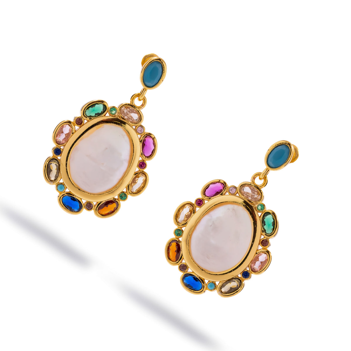 Pair of baroque pearl multicolor gemstone gold drop earrings shown at an angle on white