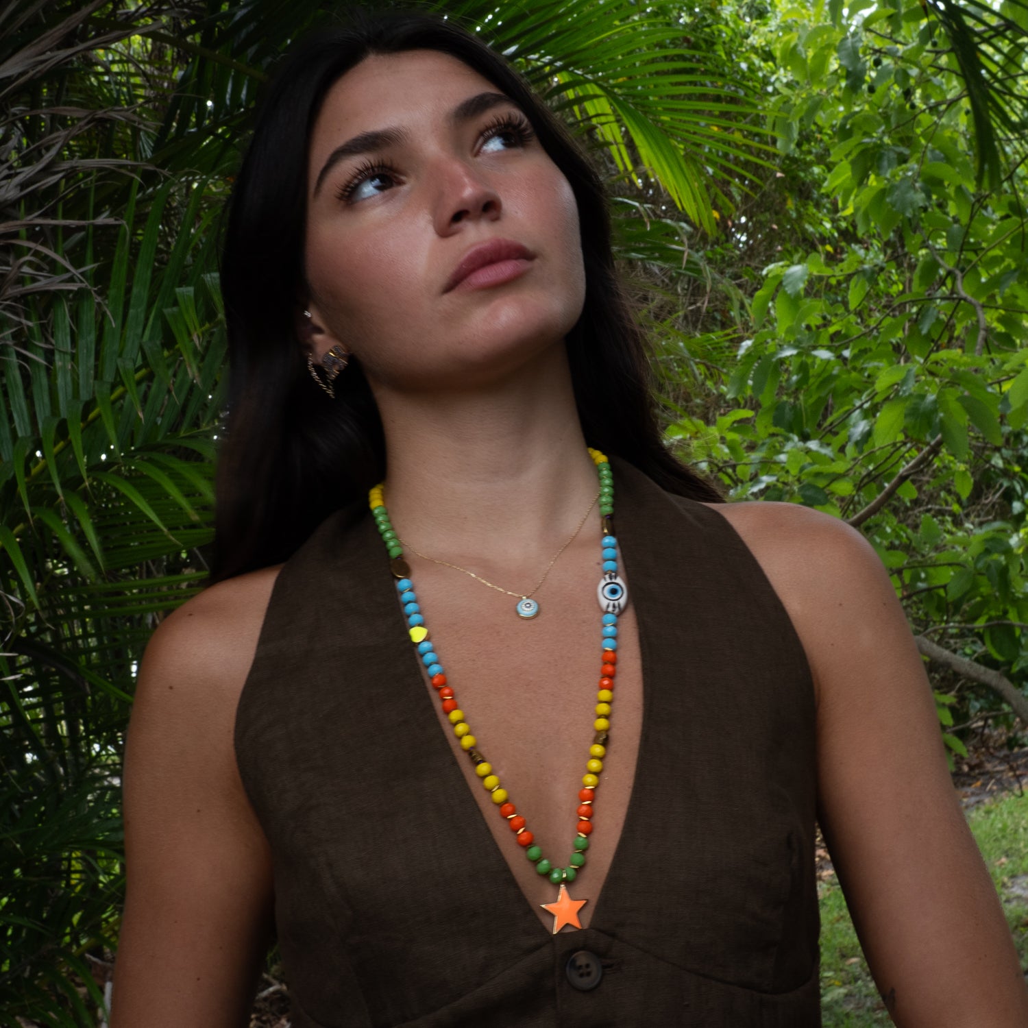 Model wearing Endless Summer star beaded necklace layered with evil eye chain, summer styling