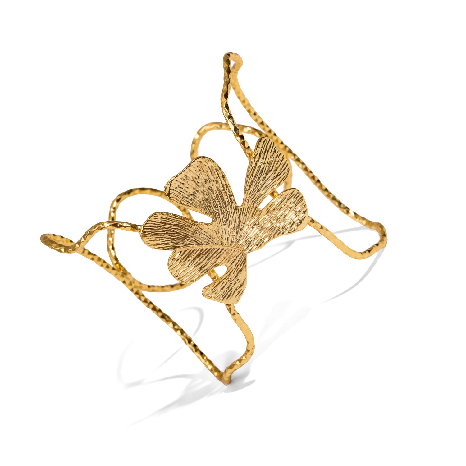 Gold bracelet with a leaf design on a white background