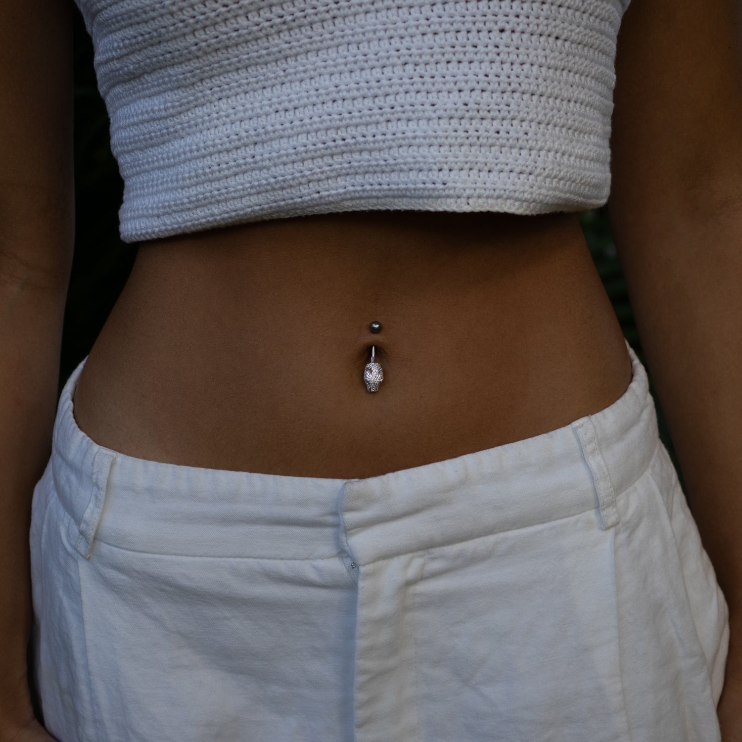 Sterling silver belly piercing with panther head, emerald green eyes, and pavé CZ diamonds