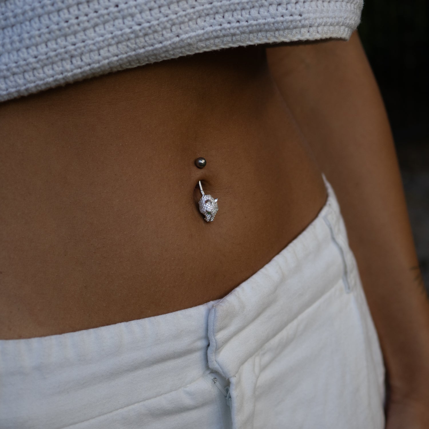 Sterling silver panther belly piercing with emerald green eyes and pavé CZ diamonds