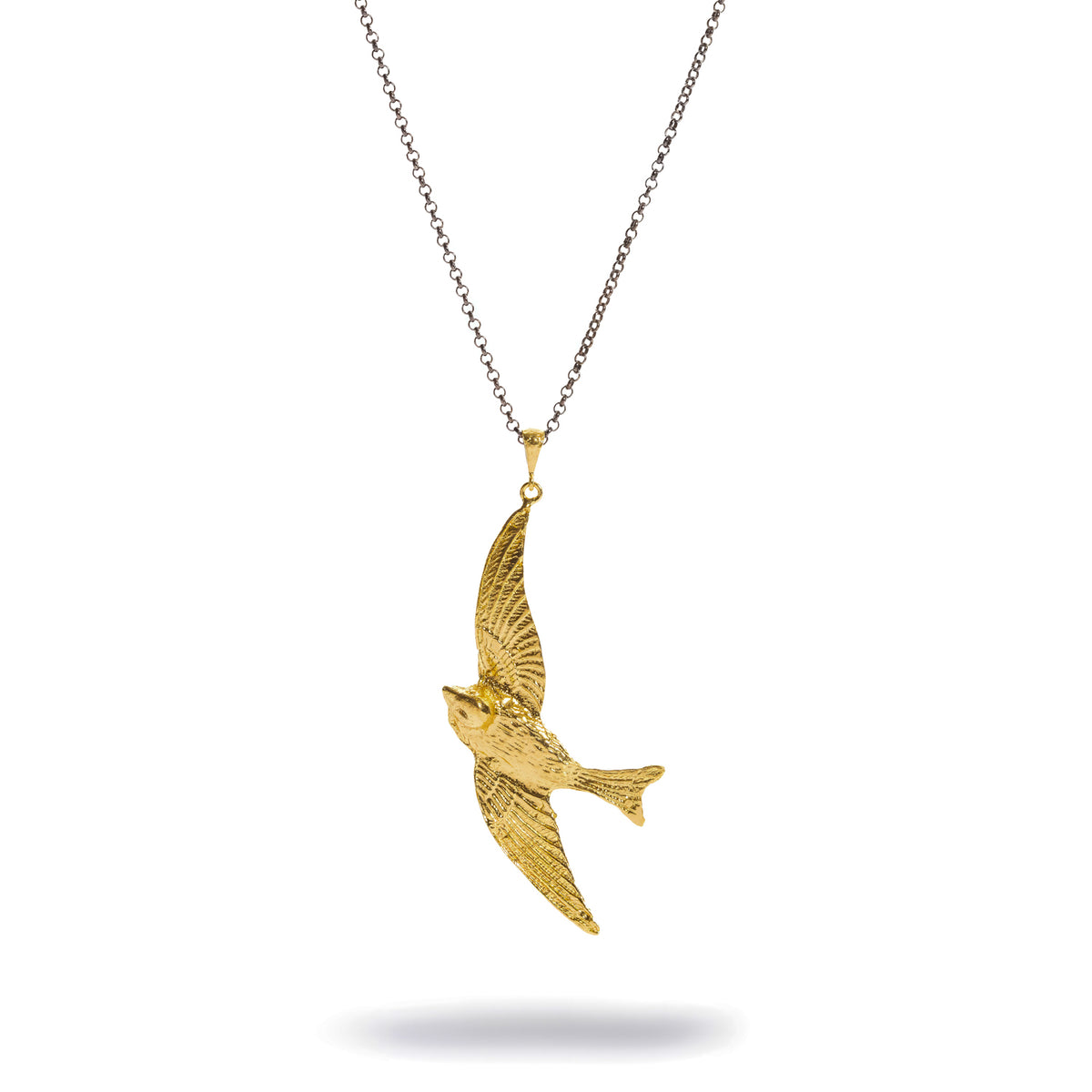 Free Spirit Sparrow Gold Pendant Two Tone Necklace laid flat, gold sparrow in flight on an oxidized silver chain