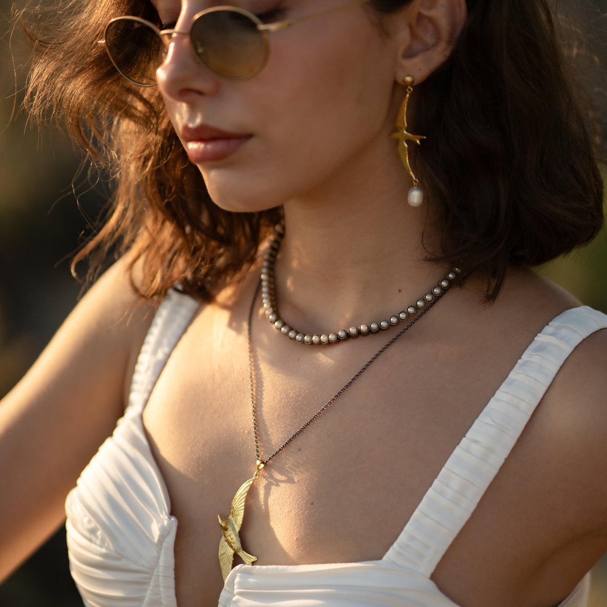 Free Spirit Sparrow Pearl Gold Drop Earrings worn with the matching Free Spirit Sparrow gold pendant necklace