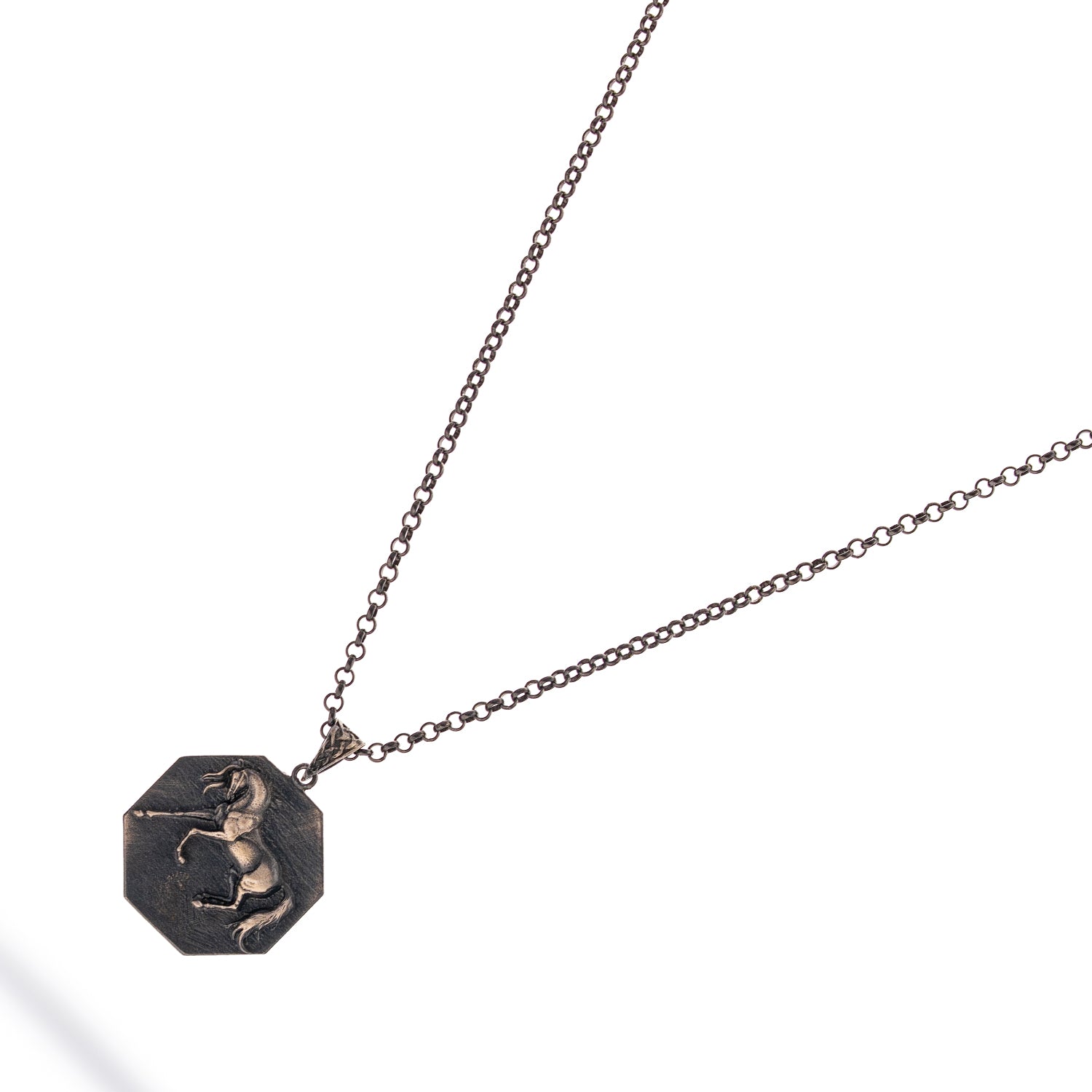 Sterling silver necklace with octagon horse medallion pendant, rhodium finish, bold masculine style symbolizing freedom and strength.