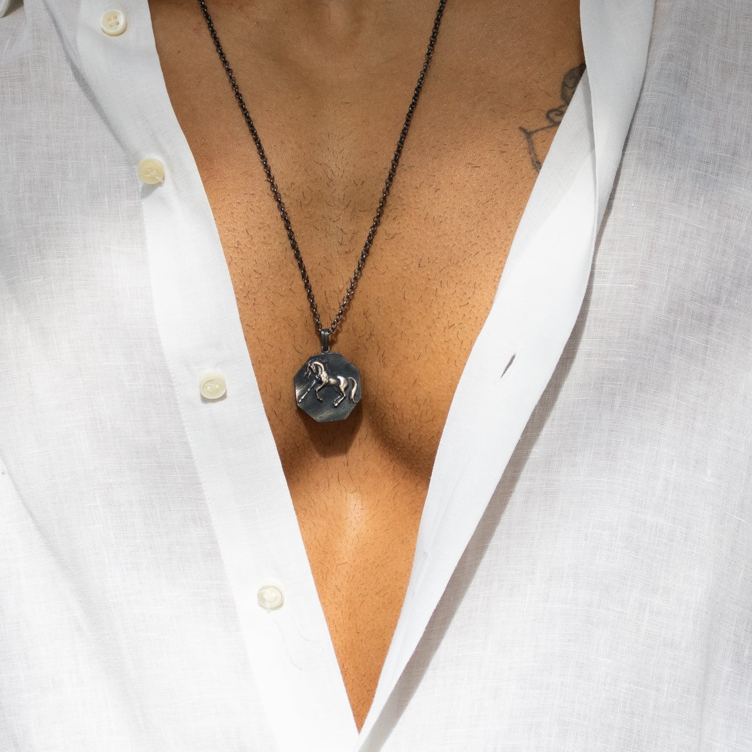 Sterling silver necklace with octagon horse medallion pendant, rhodium finish, bold masculine style symbolizing freedom and strength.