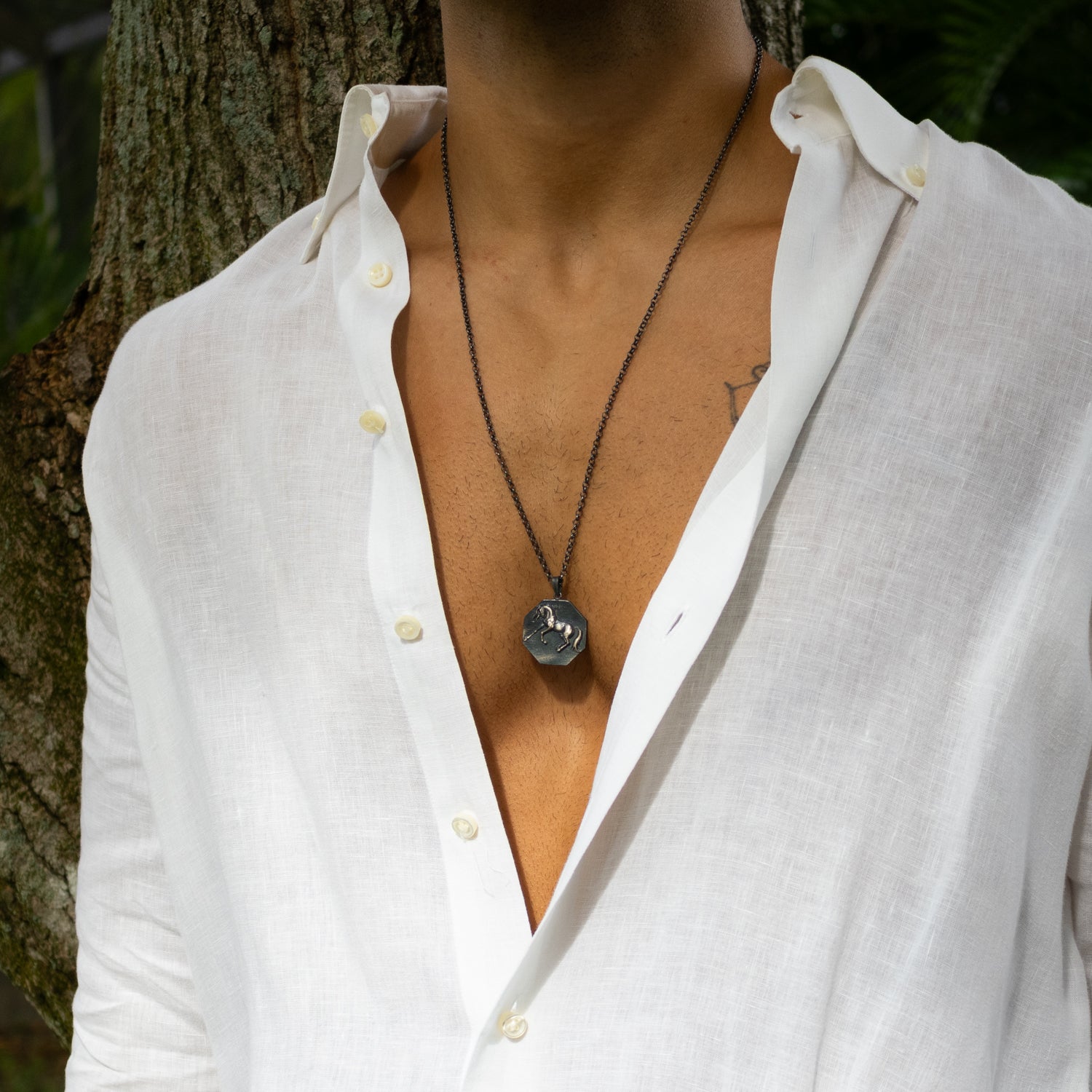 Sterling silver necklace with octagonal horse medallion pendant, rhodium finish, bold masculine style, symbolizing freedom and strength.