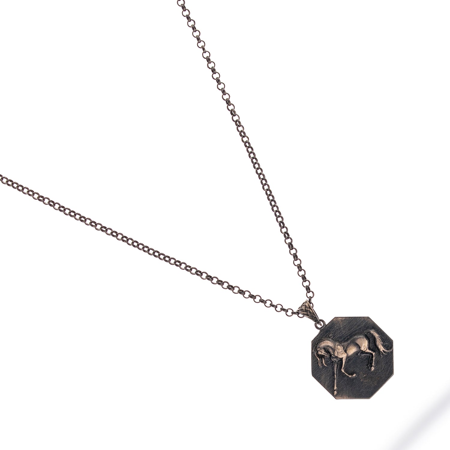 Sterling silver necklace with octagonal horse medallion pendant, rhodium finish, bold masculine style symbolizing freedom and strength.