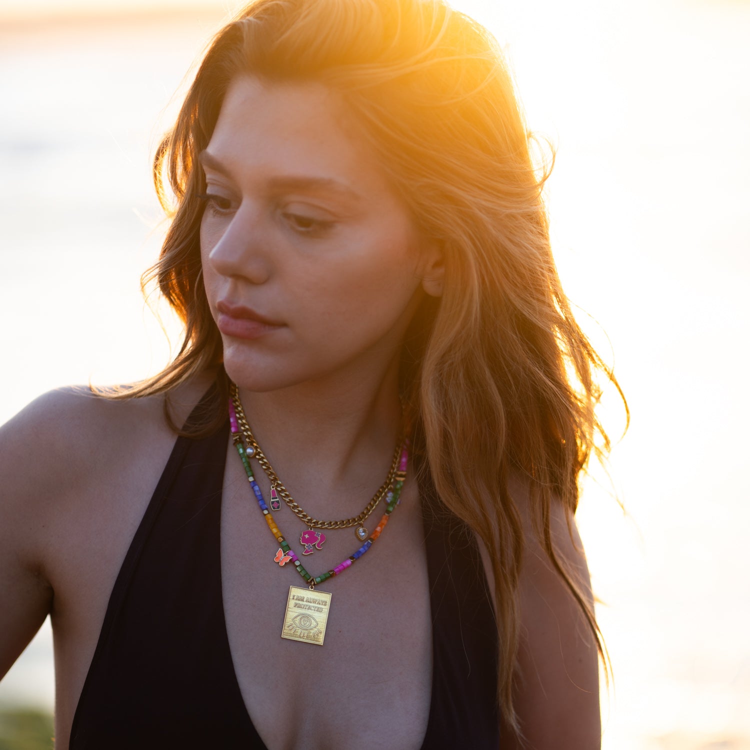 Feminine gold necklace with colorful fashion charms, perfect for everyday wear
