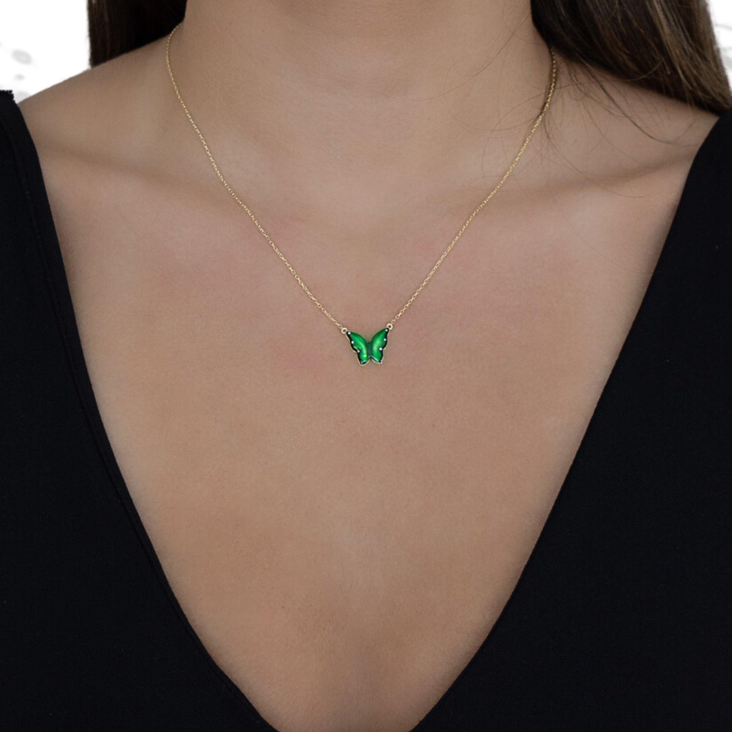 Model wearing the Gold Abundance Green Enamel Butterfly Necklace, exuding elegance and embracing the symbolism of transformation.