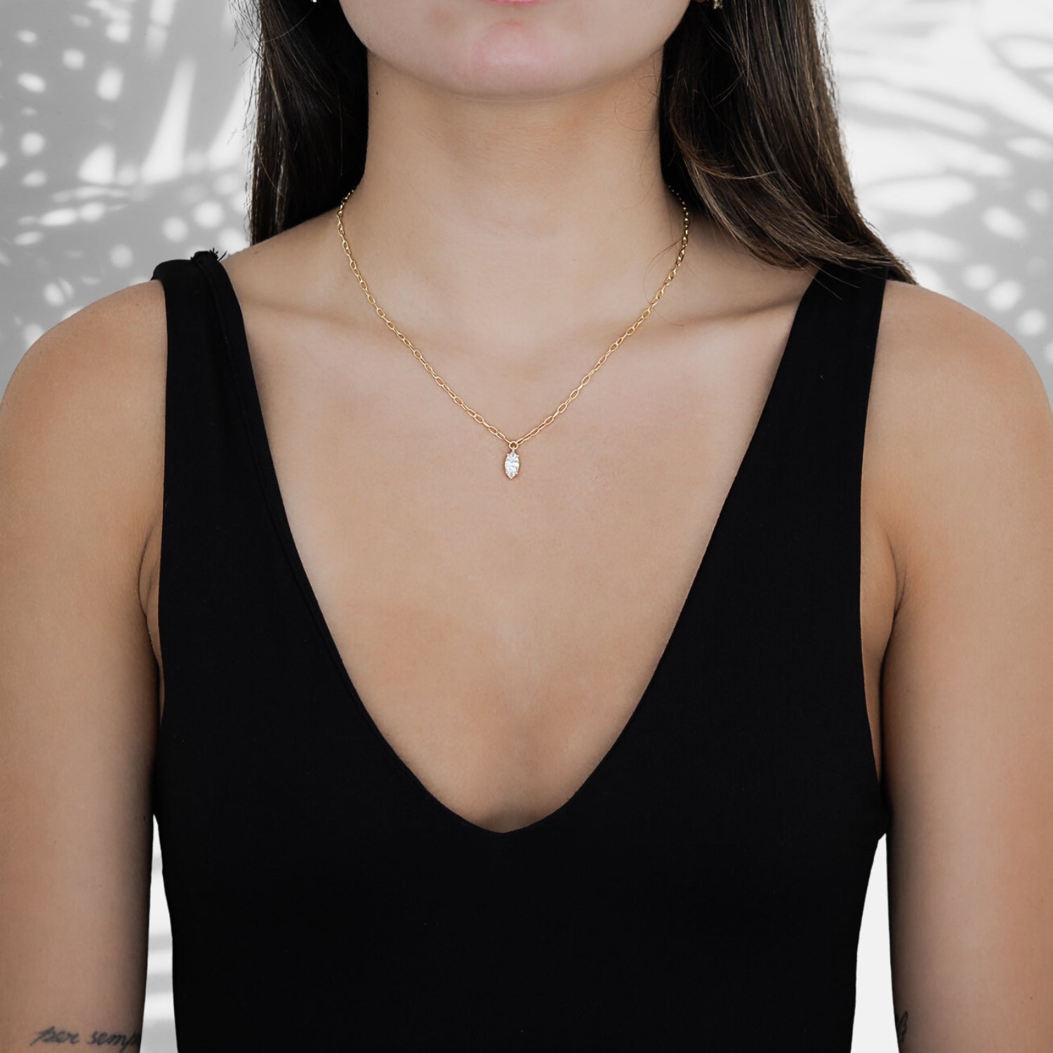 The Gold and Diamond Chain Necklace, a luxurious accessory that enhances the model&#39;s natural beauty and style.