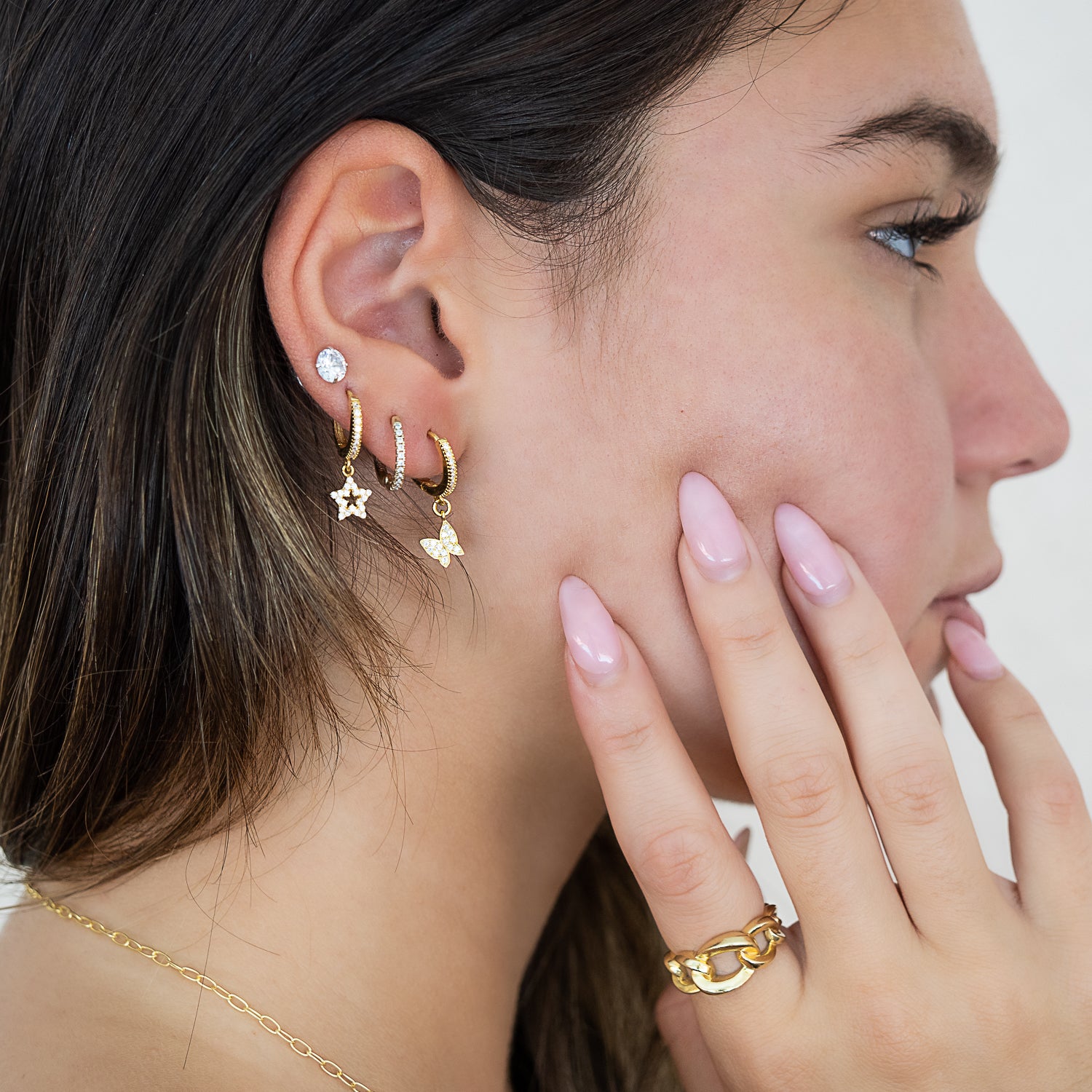 Model wearing the Gold Sparkly Butterfly Earrings, showcasing their elegance and grace