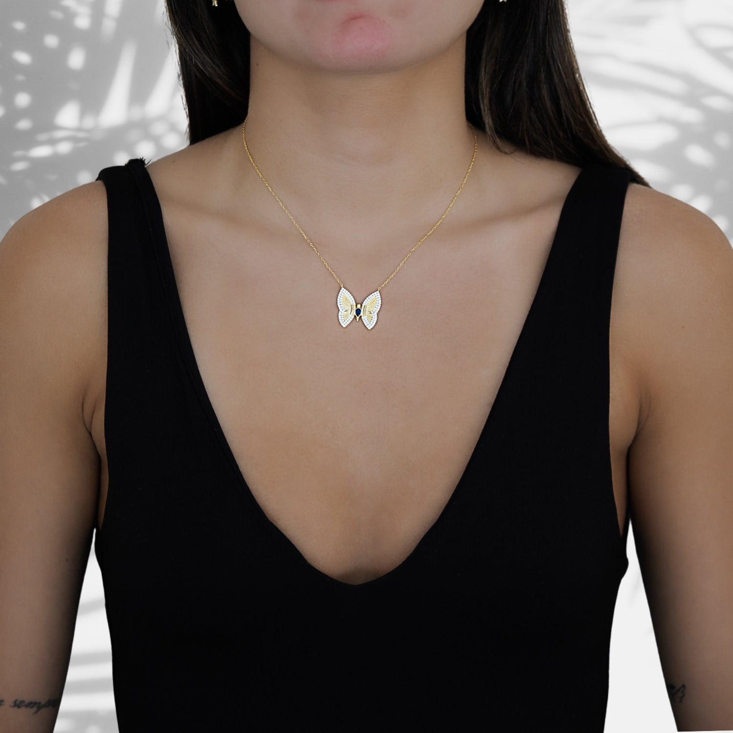Model wearing the Gold Sparkly Hope Butterfly Necklace, symbolizing resilience and embracing the power of hope and transformation.