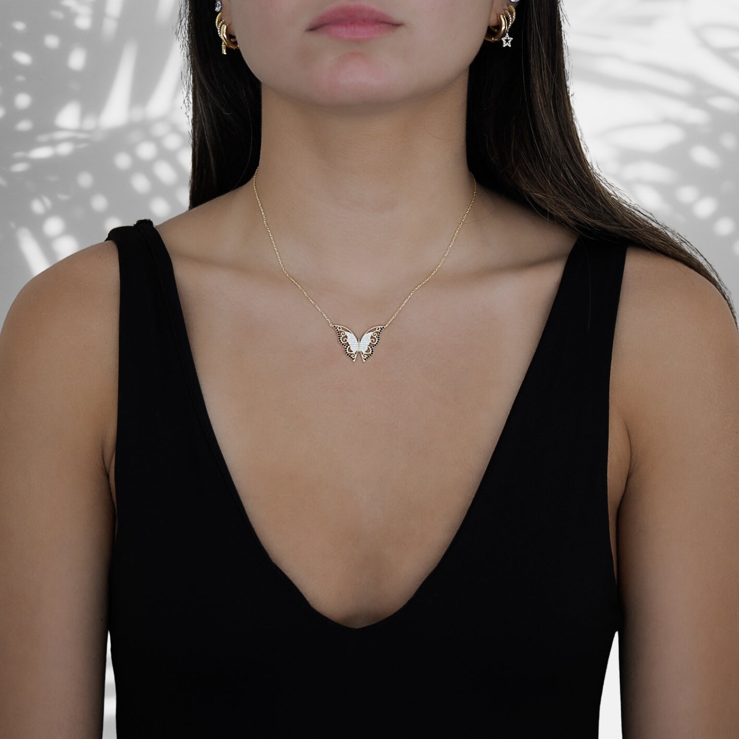 Model wearing the Gold Sparkly Joyful Butterfly Necklace, symbolizing joy and embracing the transformative power of self-discovery.