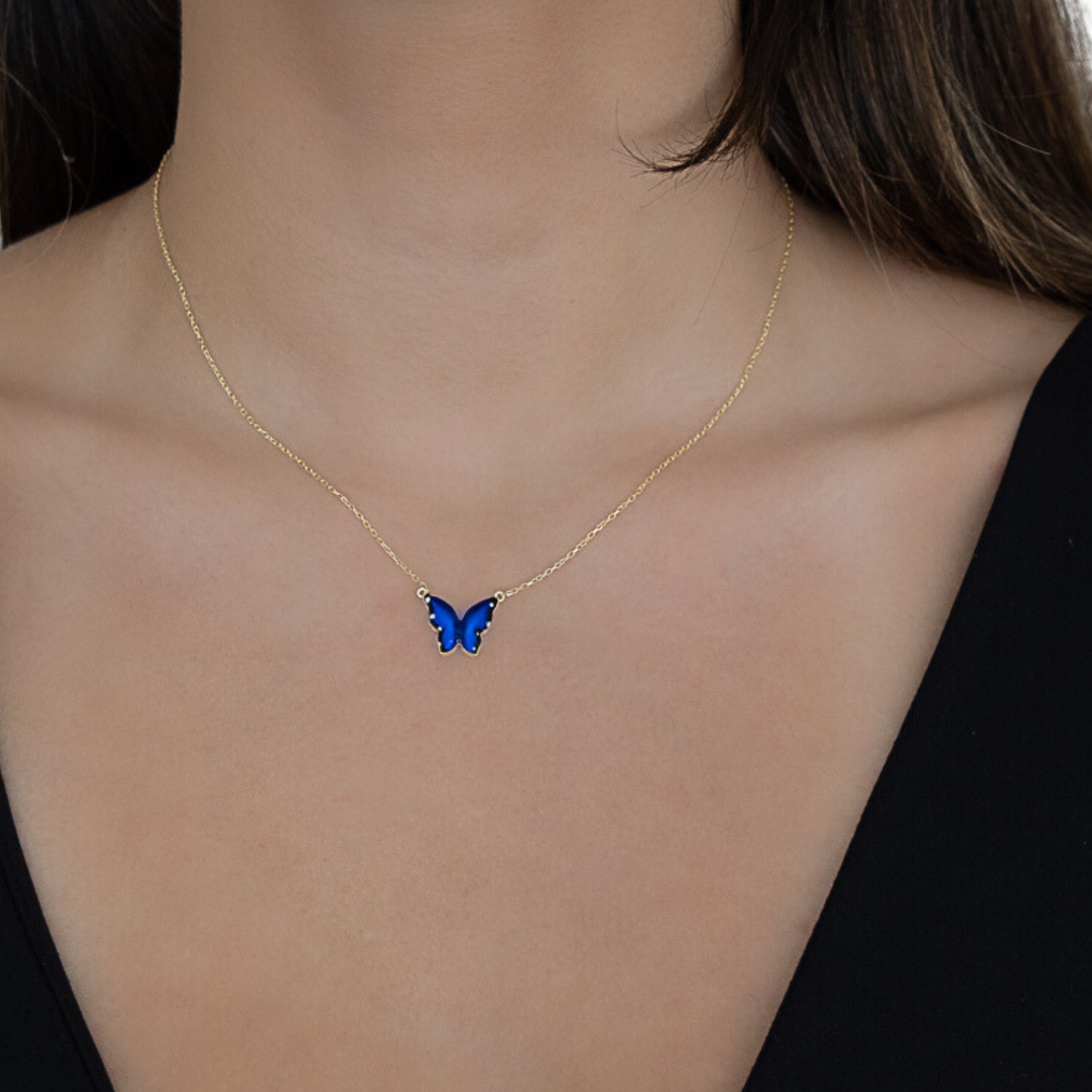Model wearing the Gold Spiritual Blue Enamel Butterfly Necklace, radiating confidence and embracing the symbolism of transformation.