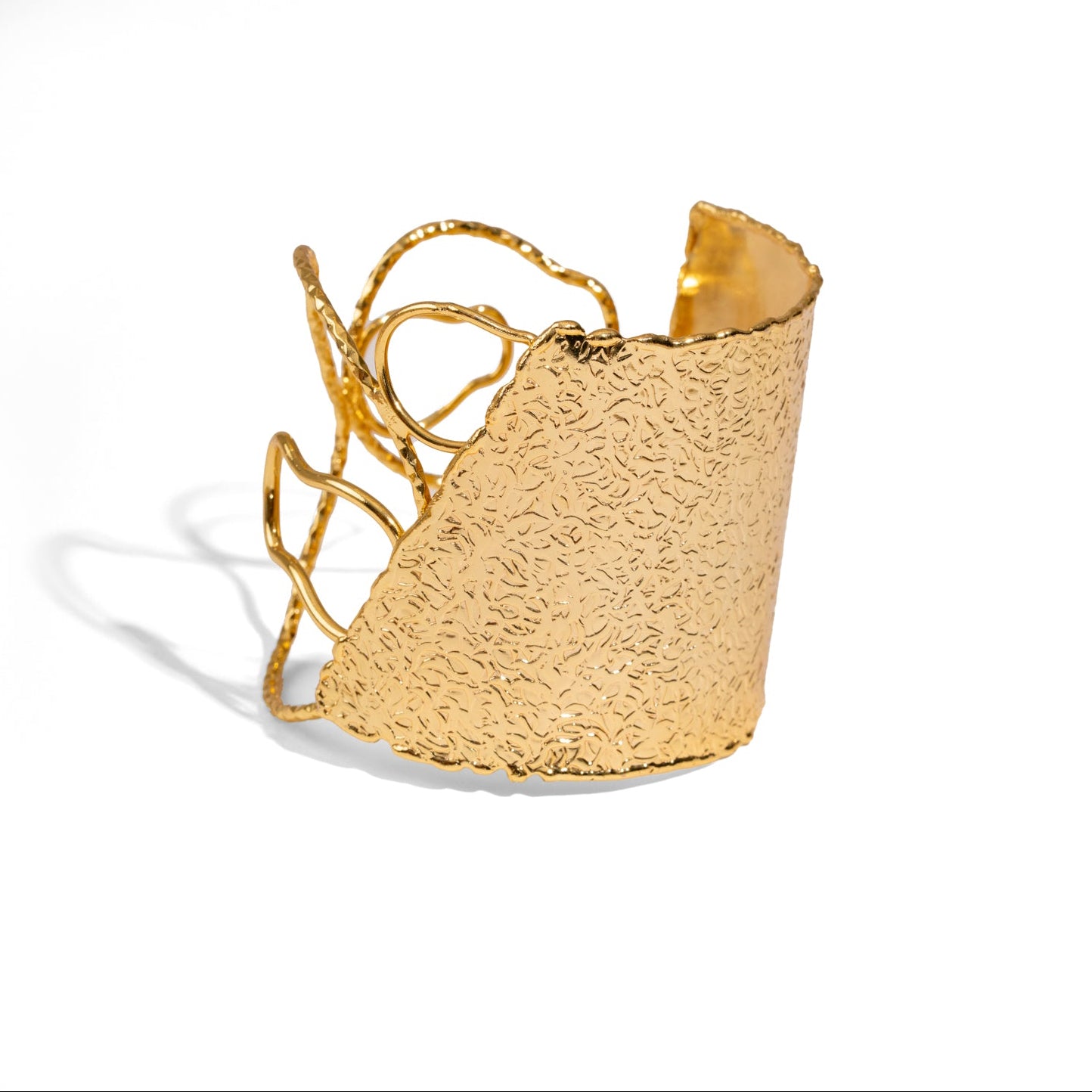 18k gold-plated bronze arm and cuff bracelet featuring a large hammered floral motif, adjustable fit, symbolizes growth and harmony.