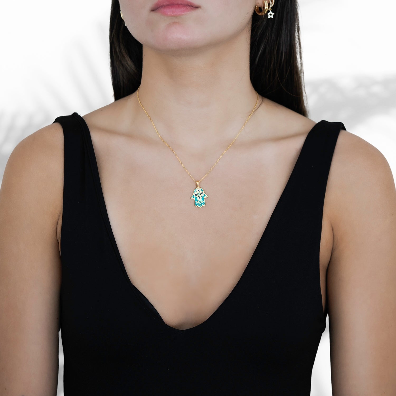 A model wearing the Good Vibes Enamel Hamsa Necklace, radiating positive energy.