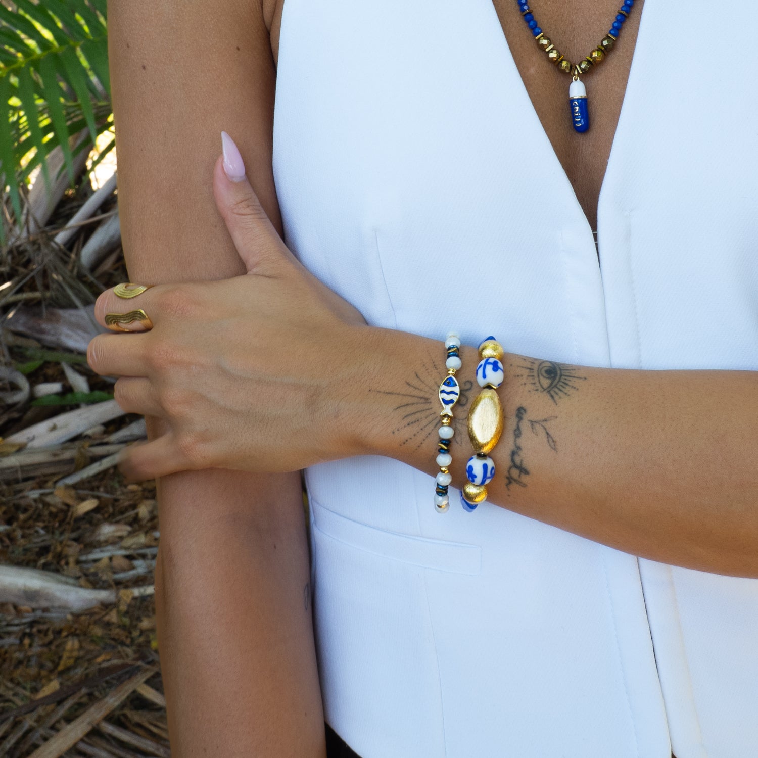 Greece Vibes Ceramic Bracelet Set worn on wrist with palm tree background — summer travel jewelry on skin