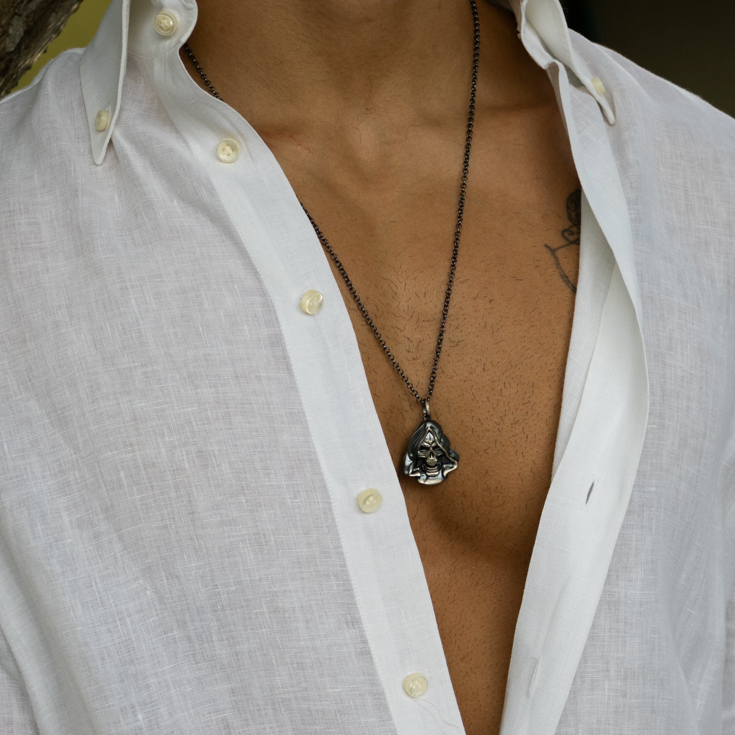 Sterling silver necklace with detailed hooded Grim Reaper skull pendant, dark rhodium-plated finish, sturdy silver chain, bold gothic style.