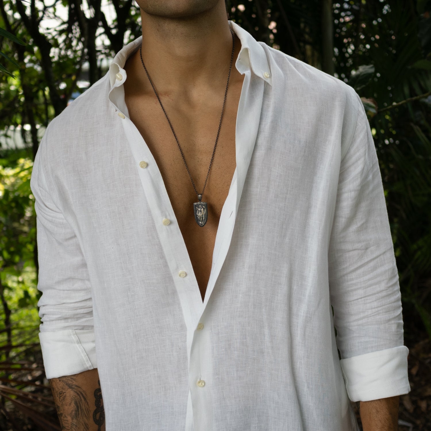 Sterling silver necklace with shield pendant featuring winged guardian angel, rhodium finish, intricate detailing, bold masculine style.