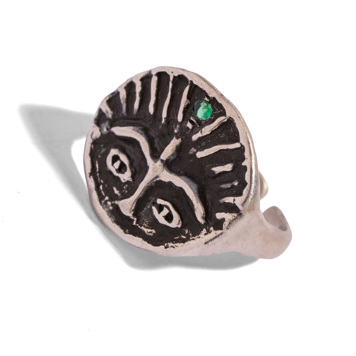 Guardian Emerald Eye Adjustable Sterling Silver Ring tilted on white, wide watchful eyes and a single green emerald