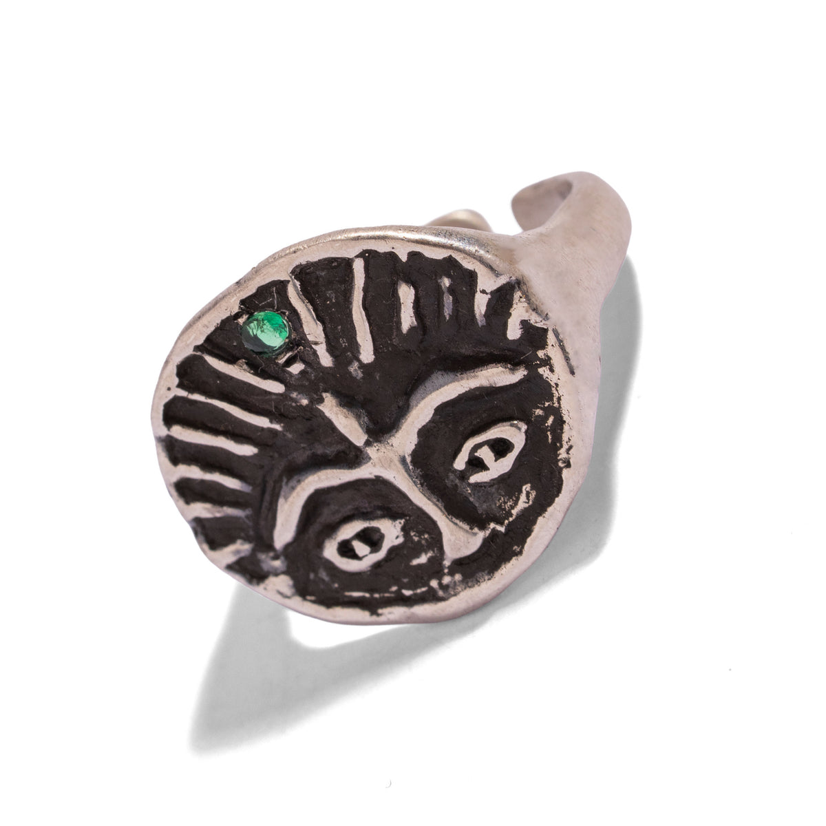 Guardian Emerald Eye sterling silver signet ring at an angle, oxidized carving and emerald accent in detail