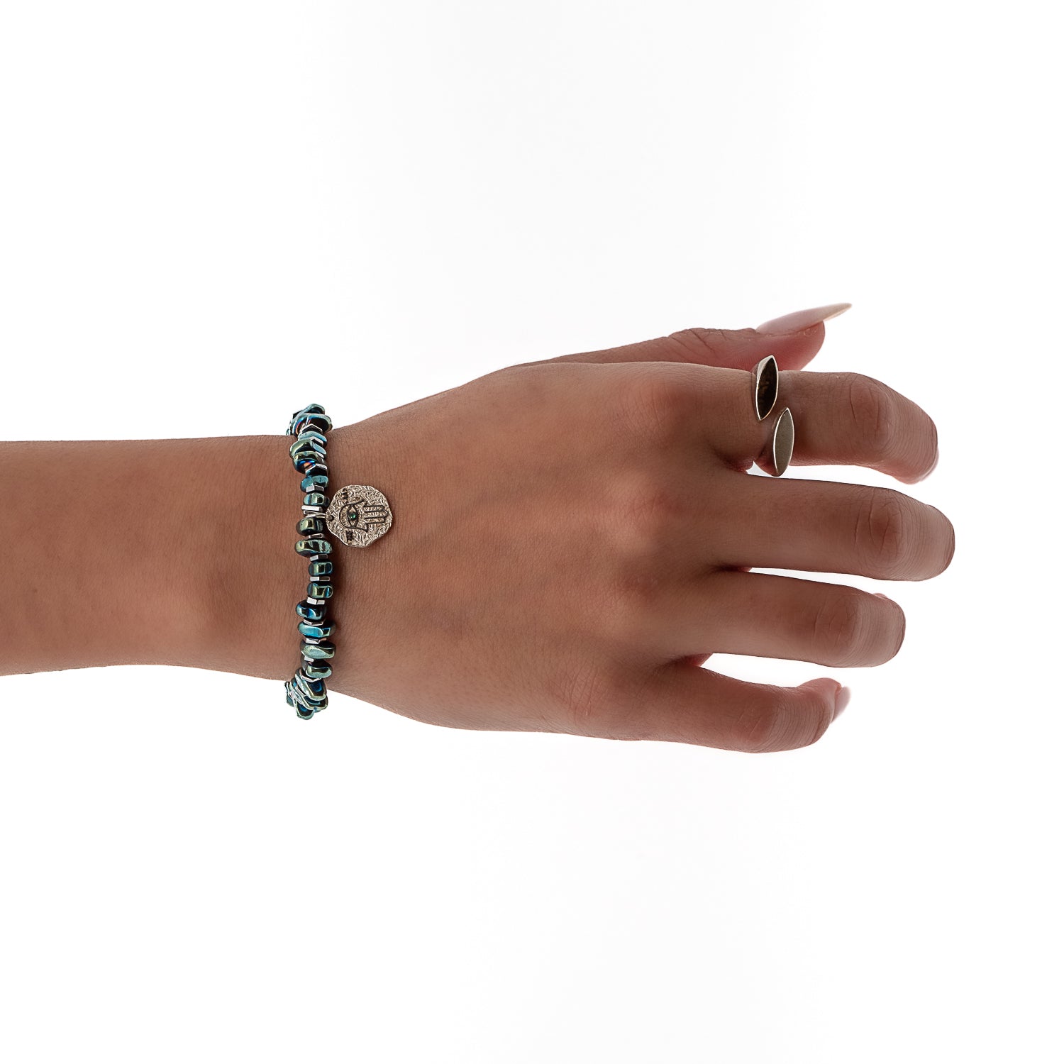A hand wearing the Guardian Hamsa Bracelet, showcasing how it beautifully adorns the wrist. 