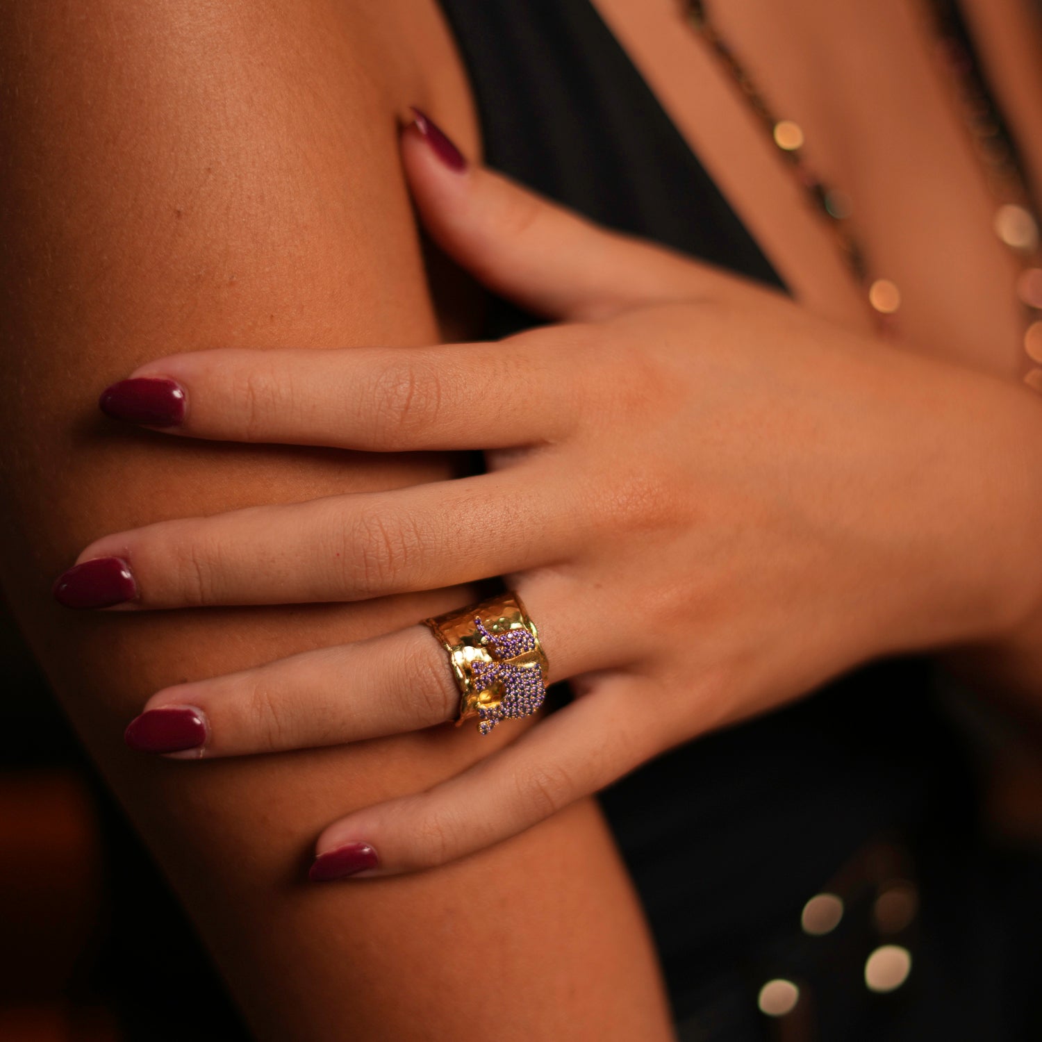 Statement ring featuring a lucky elephant with sparkling purple Swarovski crystals, set in 24k gold-plated brass with an adjustable band.
