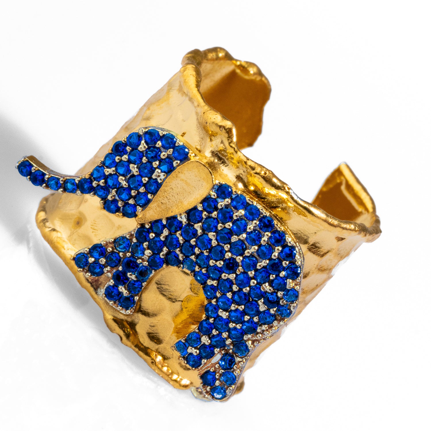 Elegant chunky gold ring with sapphire-studded elephant design, crafted from 24k gold-plated brass, adjustable for versatile wear.
