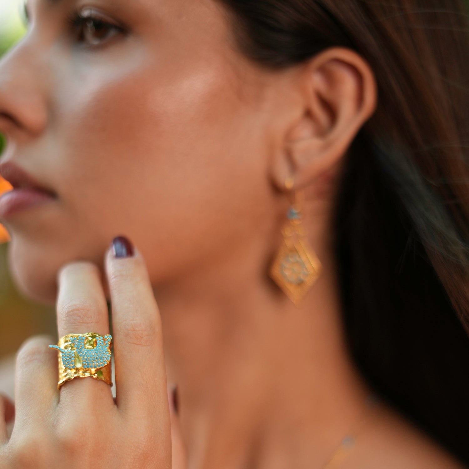 Gold chunky ring with a turquoise-studded elephant, crafted from 24k gold-plated brass and designed with an adjustable band for comfort.
