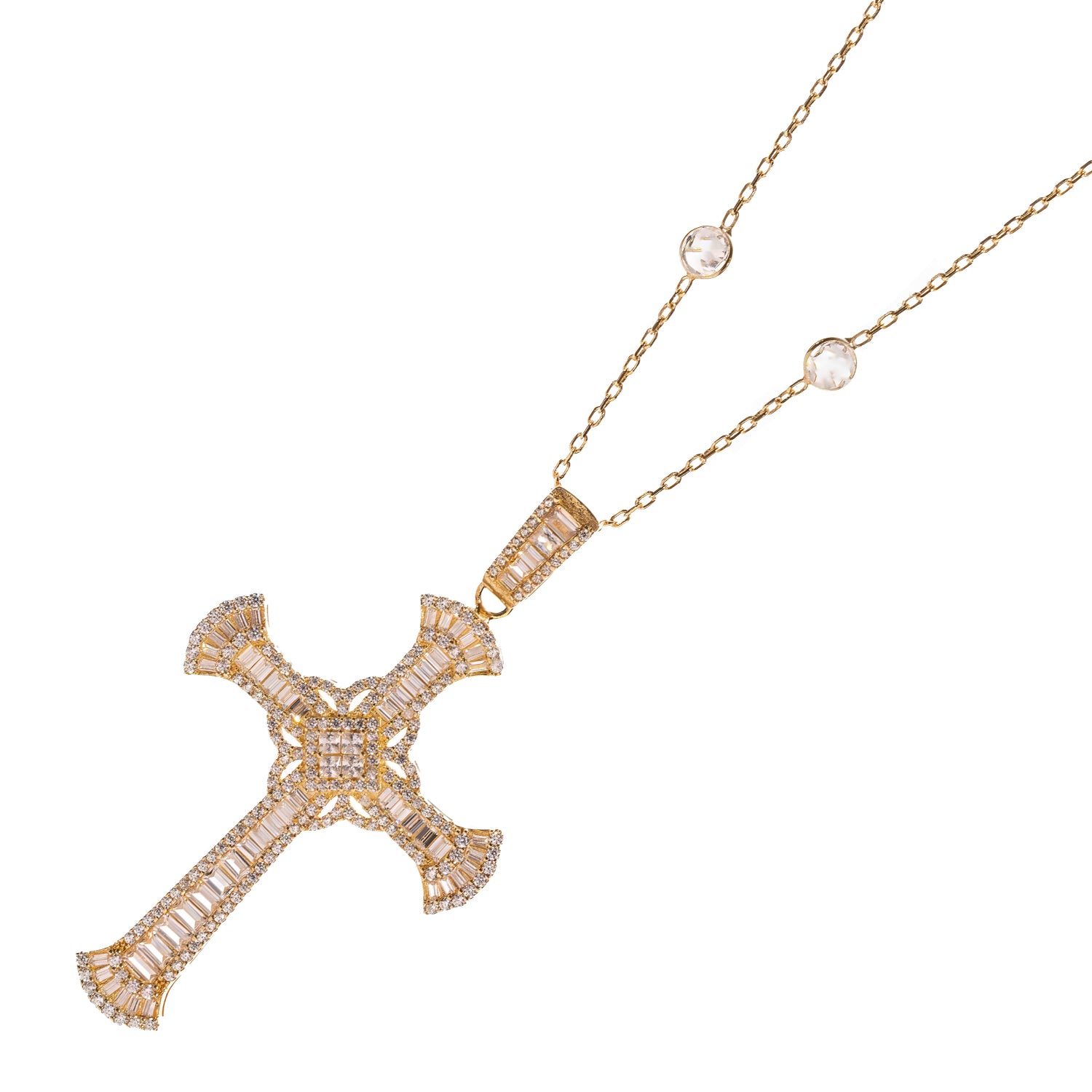 Detail of a baguette set gold cross pendant and its bezelled station chain