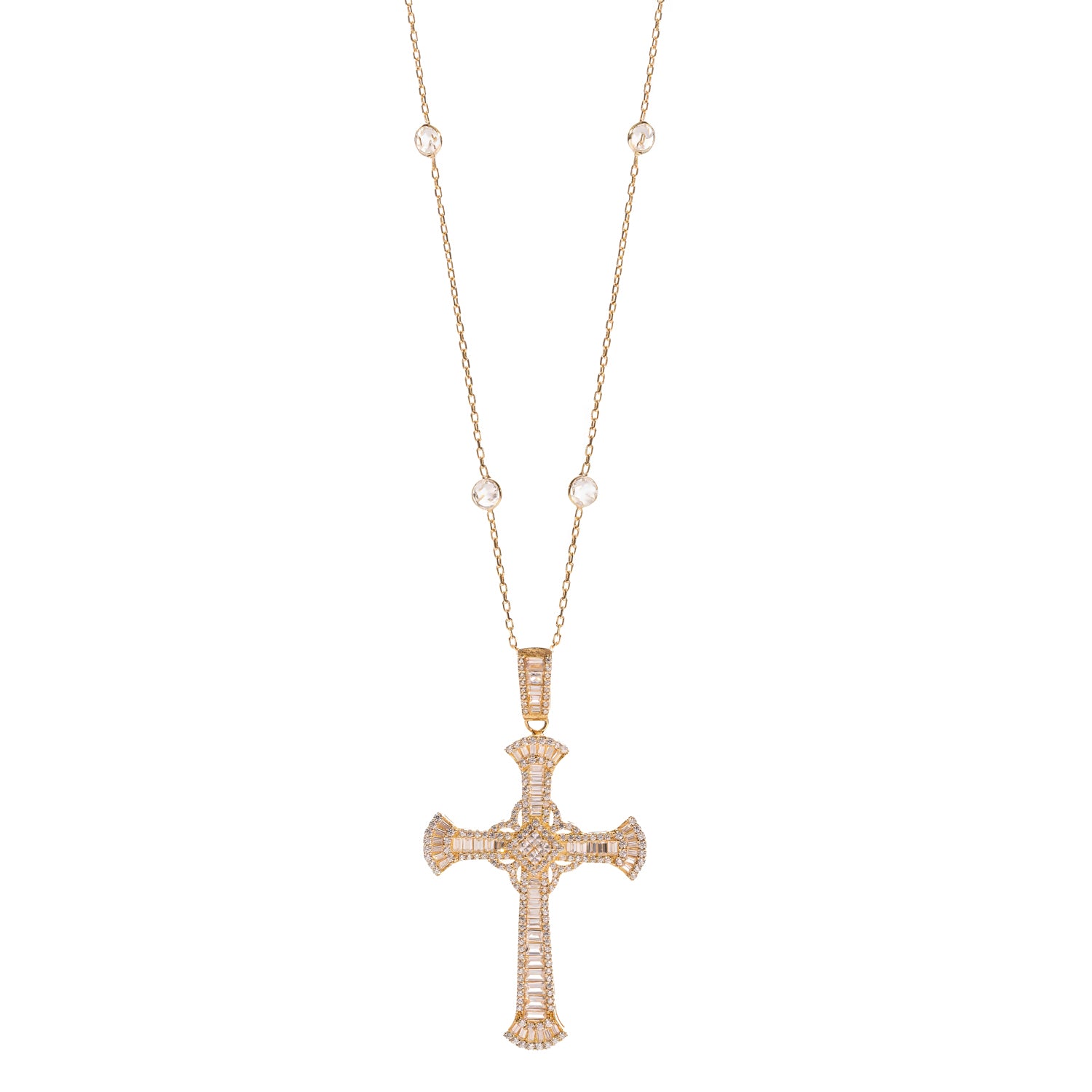 Gold cross pendant paved in baguette cubic zirconia on a station chain, white background
