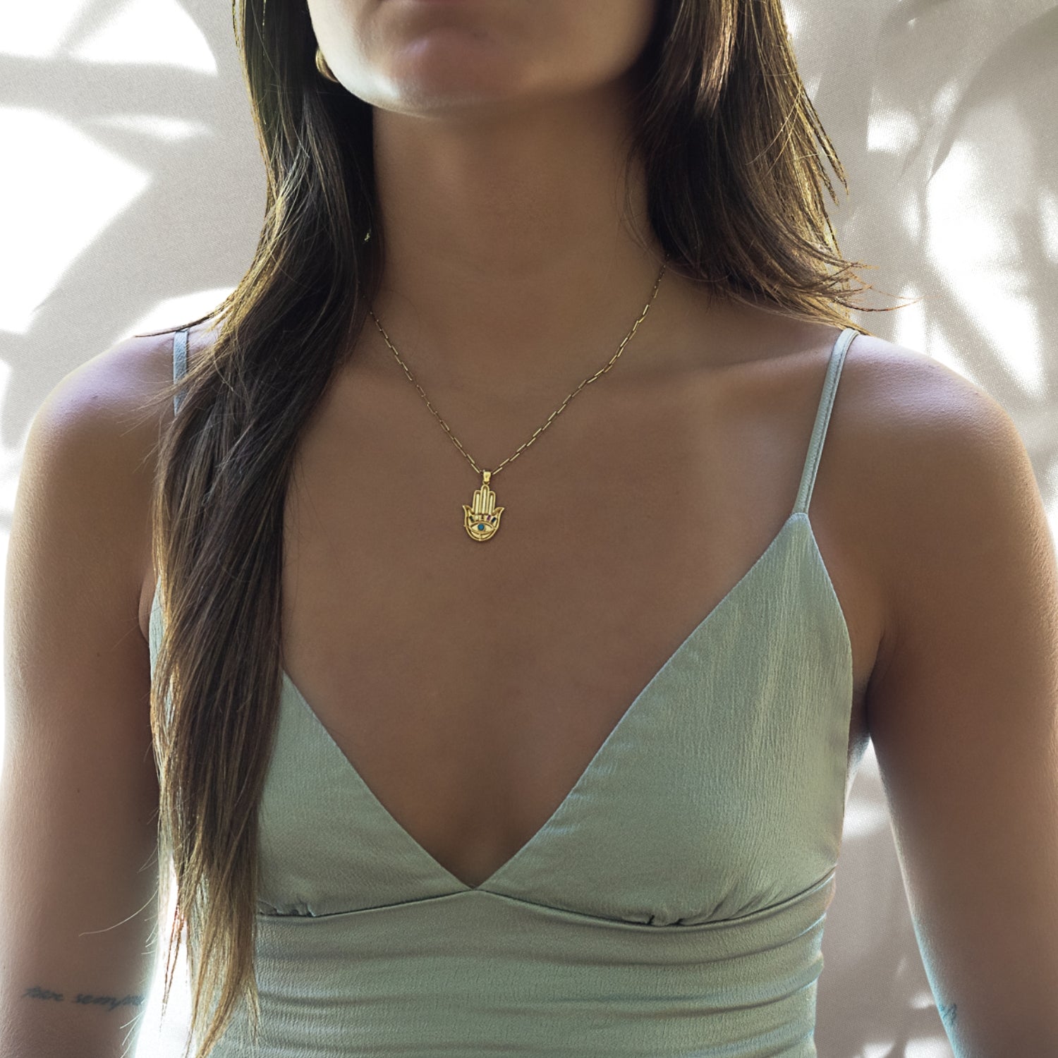 Model Wearing Hamsa Talisman Necklace - See how this stunning gold necklace with a turquoise Hamsa pendant enhances the style and brings a touch of spirituality to any outfit.