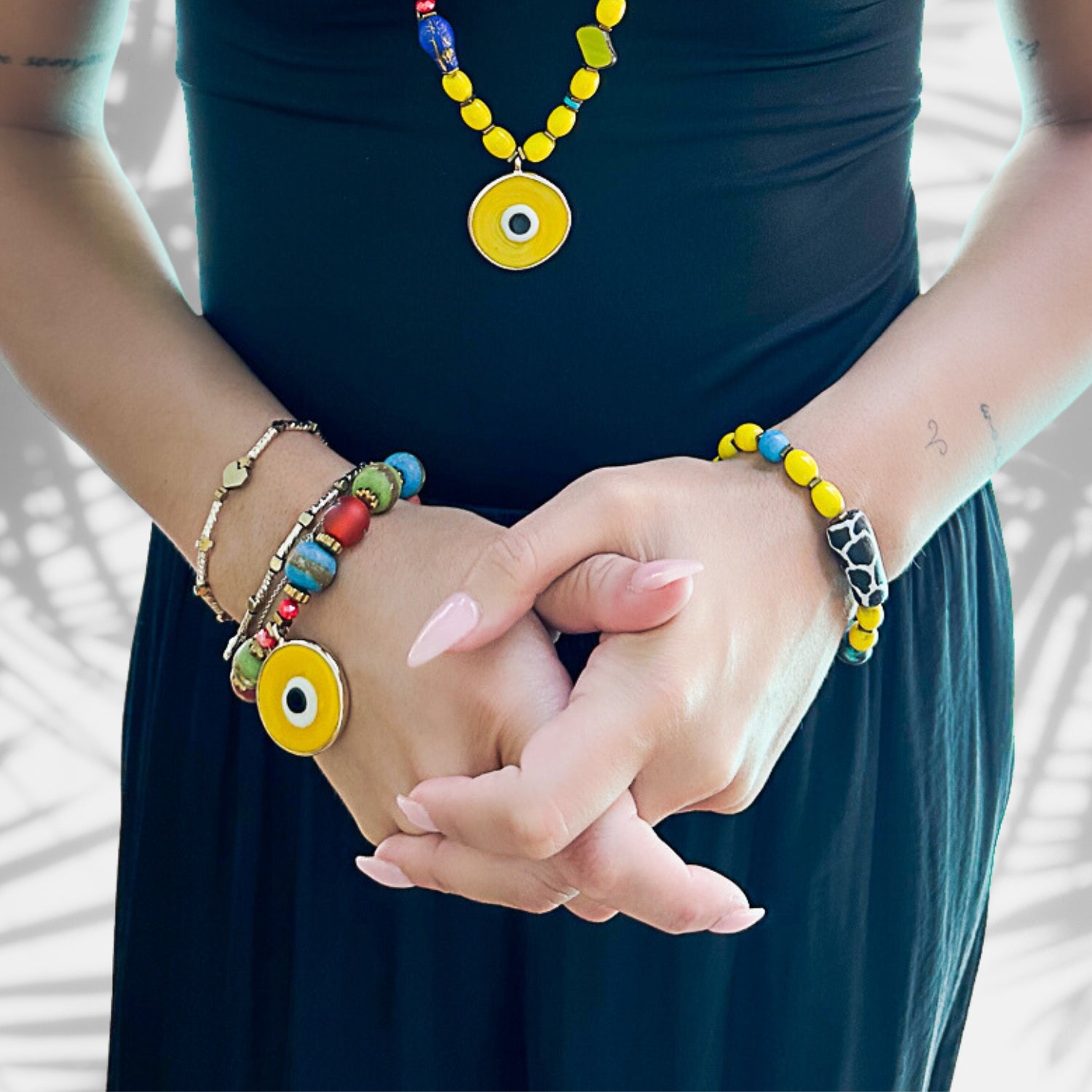 An image of a hand model wearing the Happiness Symbol Yellow Bracelet, showcasing how it adds a vibrant and meaningful touch to the wrist, creating a stylish and uplifting accessory.