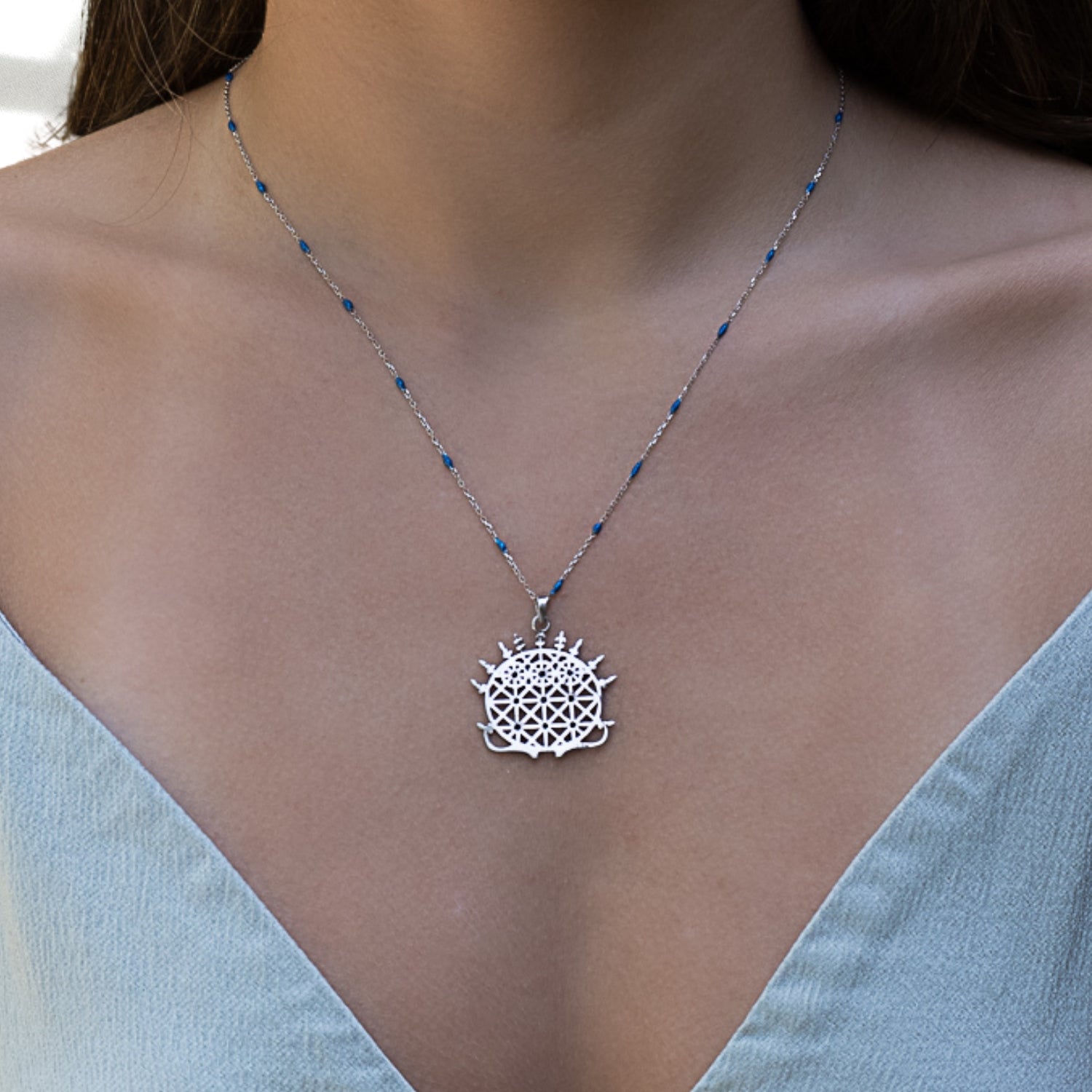 Enhance your look with the Hittite Sun Disk Necklace, as seen on our model showcasing its beauty and elegance.