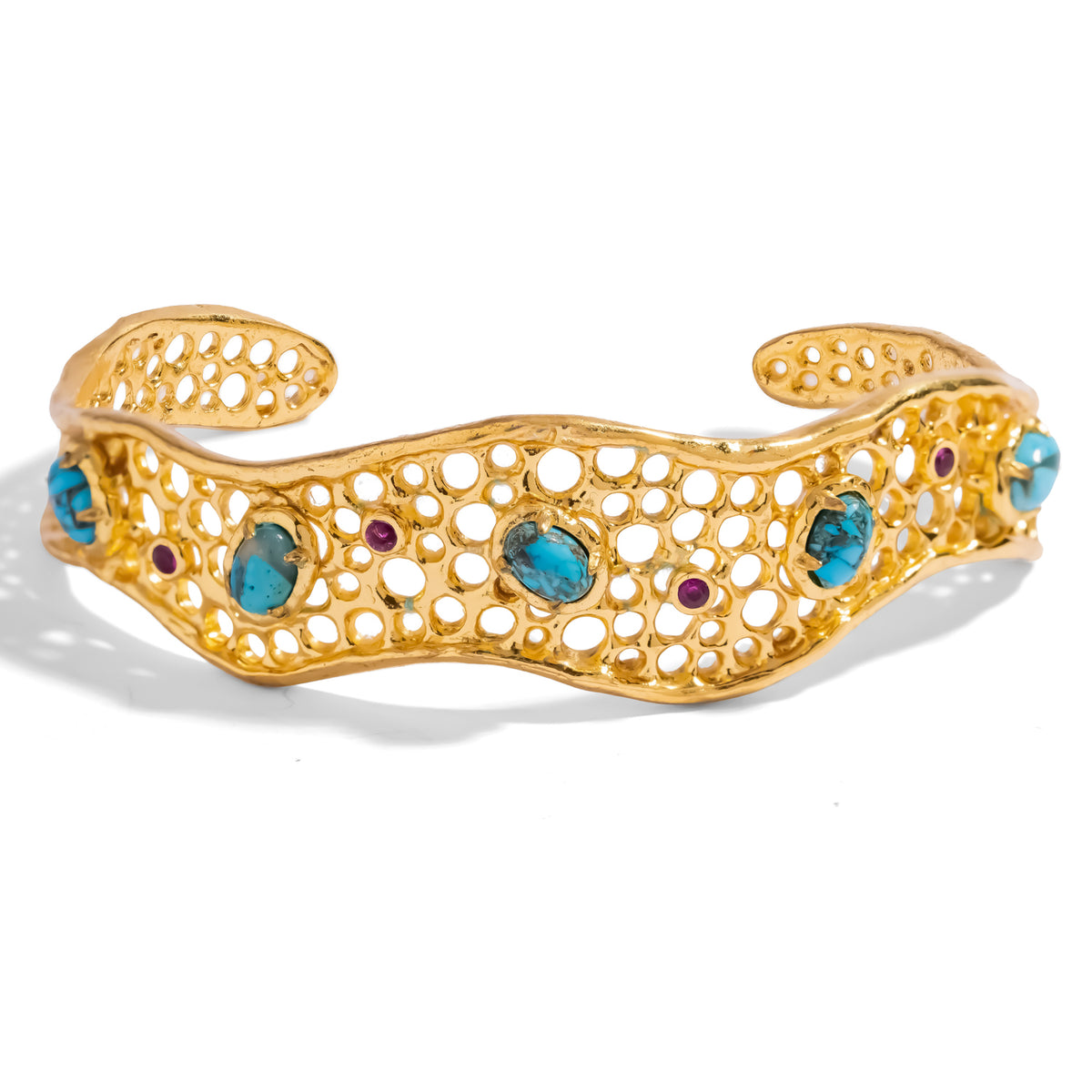 Front view of the Honeycomb Lace Turquoise & Ruby Gold Cuff Bracelet, raw turquoise cabochons set among the pierced gold cells