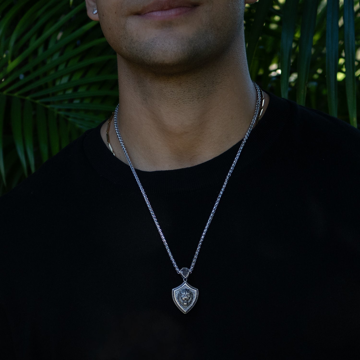 Lionheart Shield men’s necklace in sterling silver with a raised lion head pendant, rhodium finish, and polished silver chain.