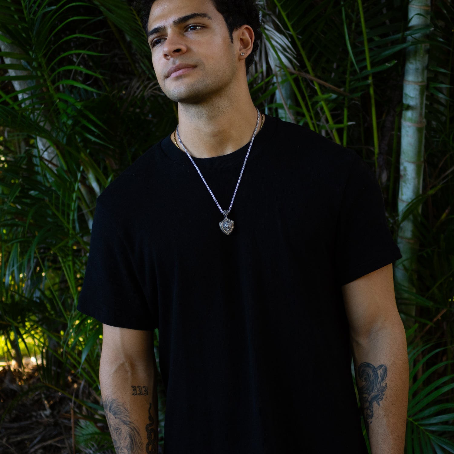 Sterling silver Lionheart Shield men’s necklace with an embossed lion head pendant, rhodium finish, and polished silver chain.