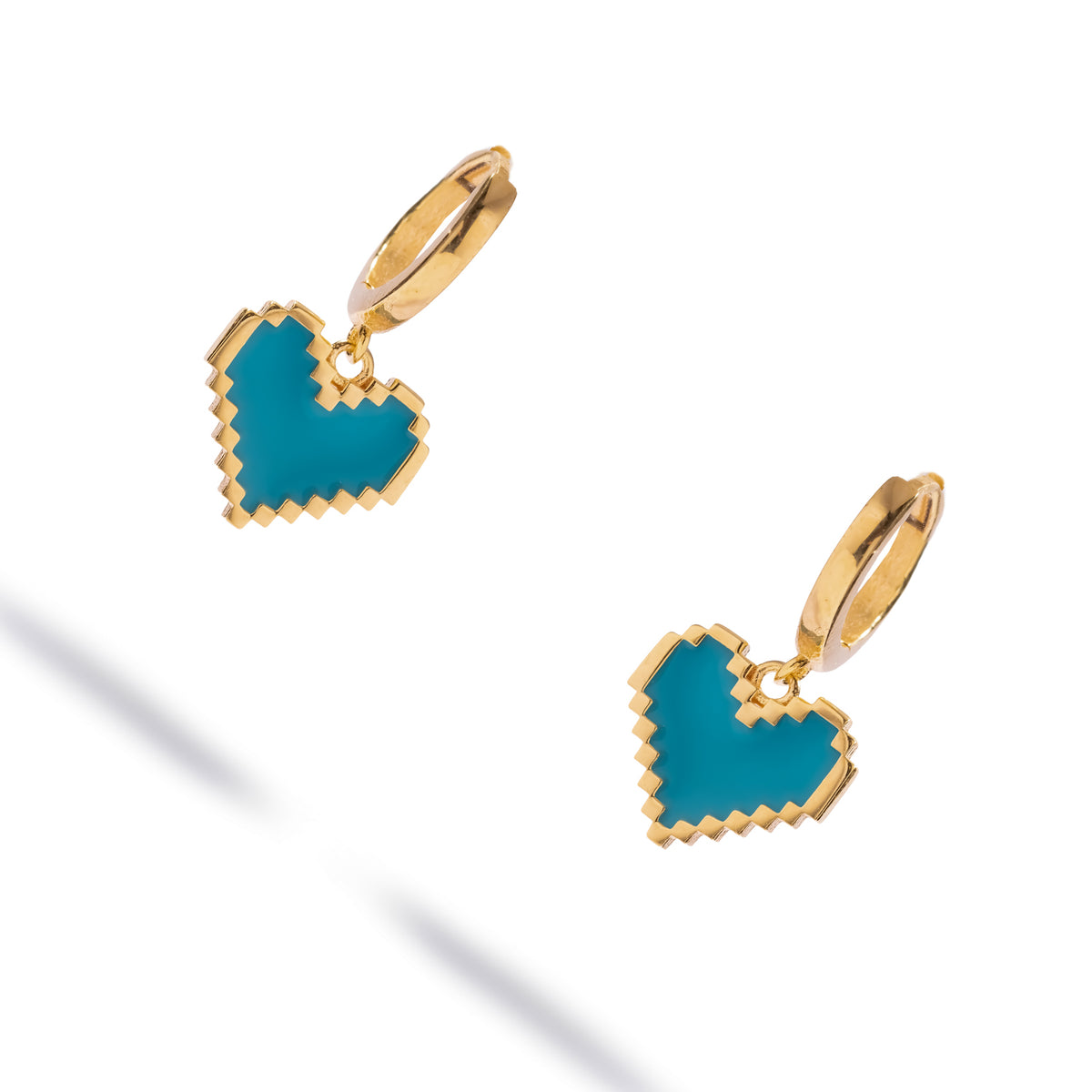 Turquoise enamel heart gold hoop earrings shown at an angle, revealing the huggie hoops and raised gold edges