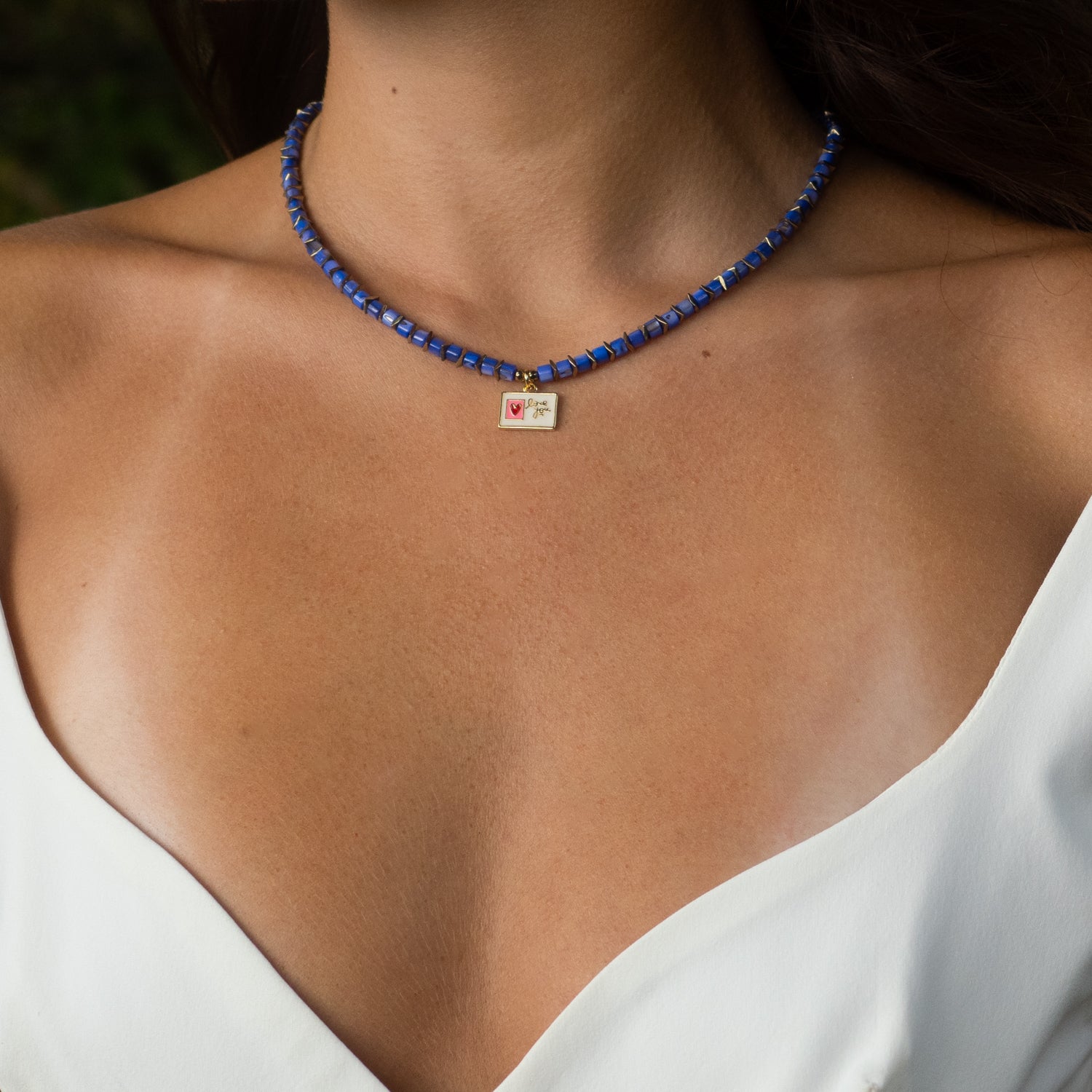 Purple-blue bead choker featuring gold hematite spacers and sweet love message charm.

