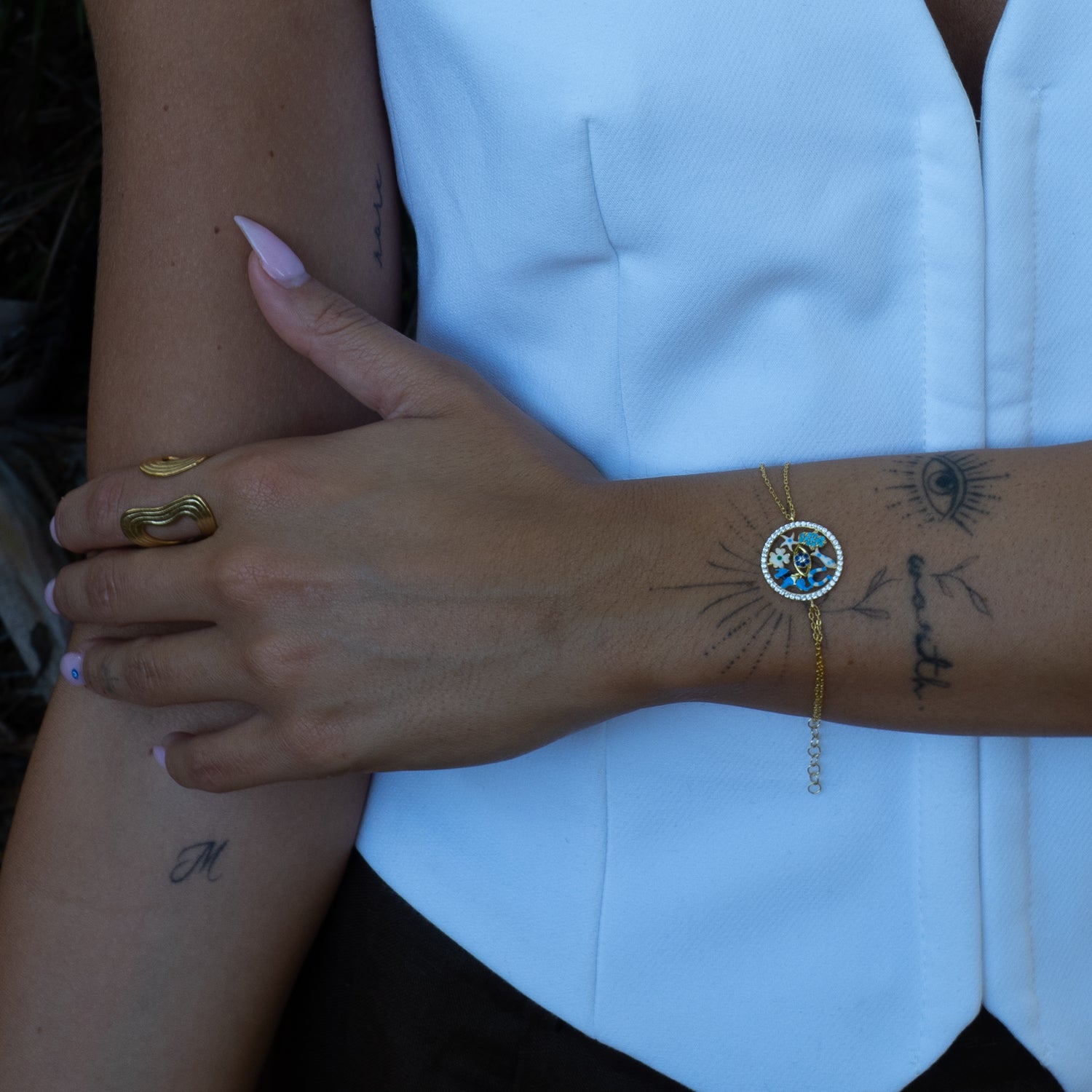 Model wearing Lucky Charms talisman bracelet with good luck medallion by Ebru Jewelry
