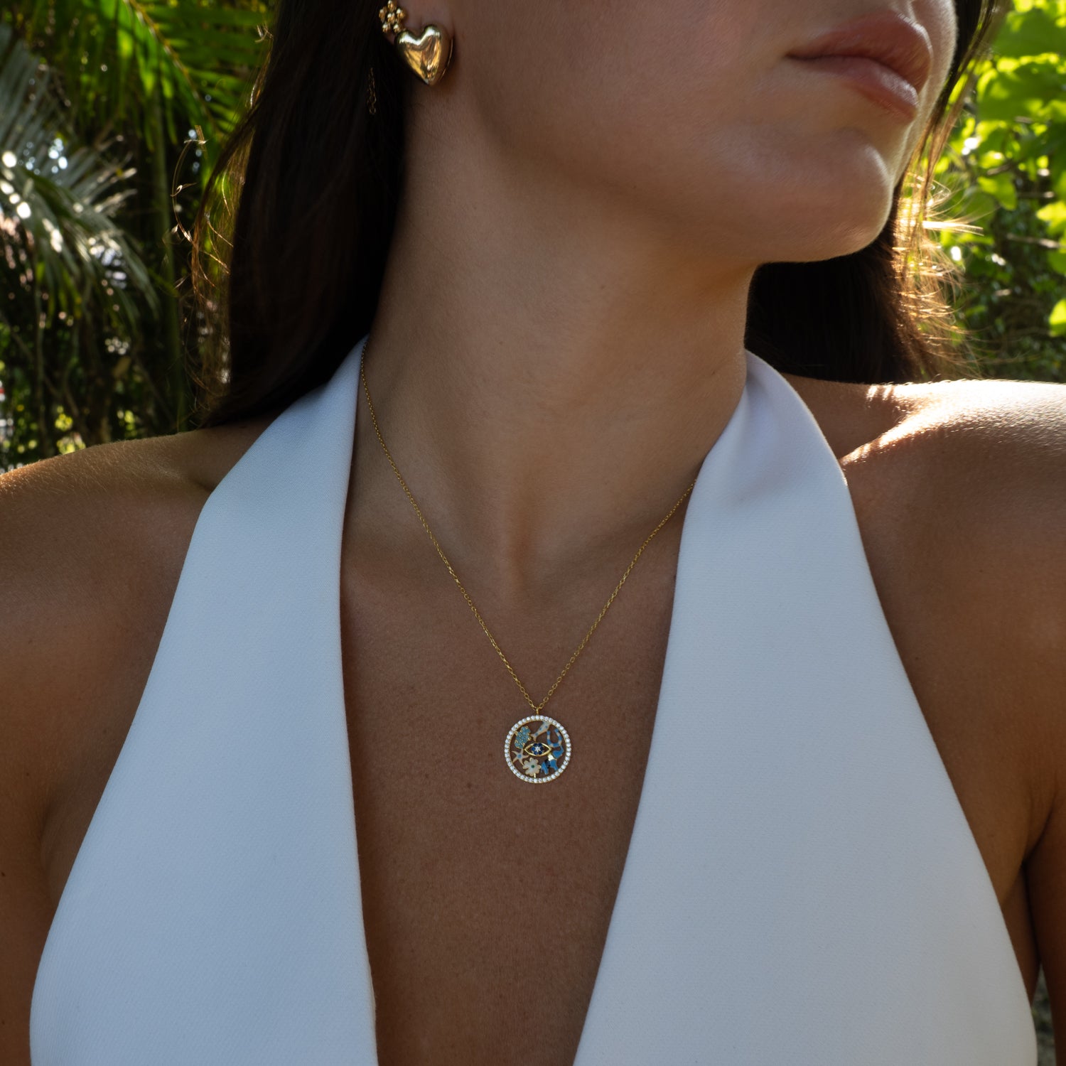 Close-up of good luck medallion pendant necklace on model by Ebru Jewelry