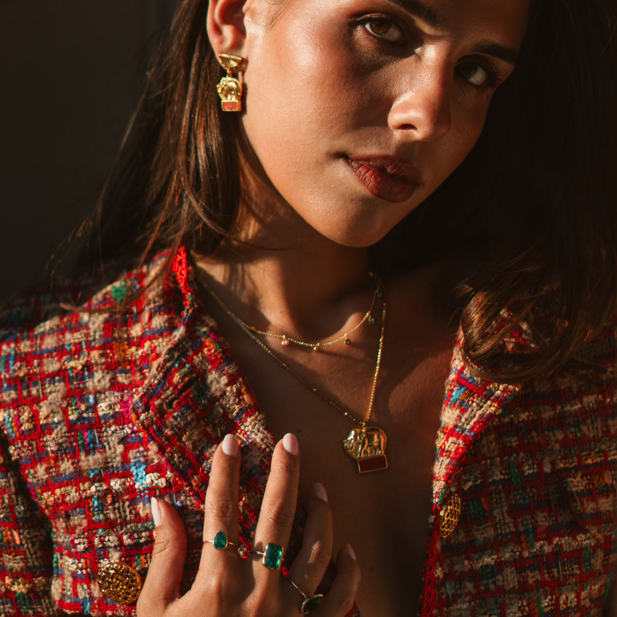 Model wearing the Lucky Elephant Coral Mosaic Gold Drop Earrings with layered Ebru Jewelry necklaces and rings