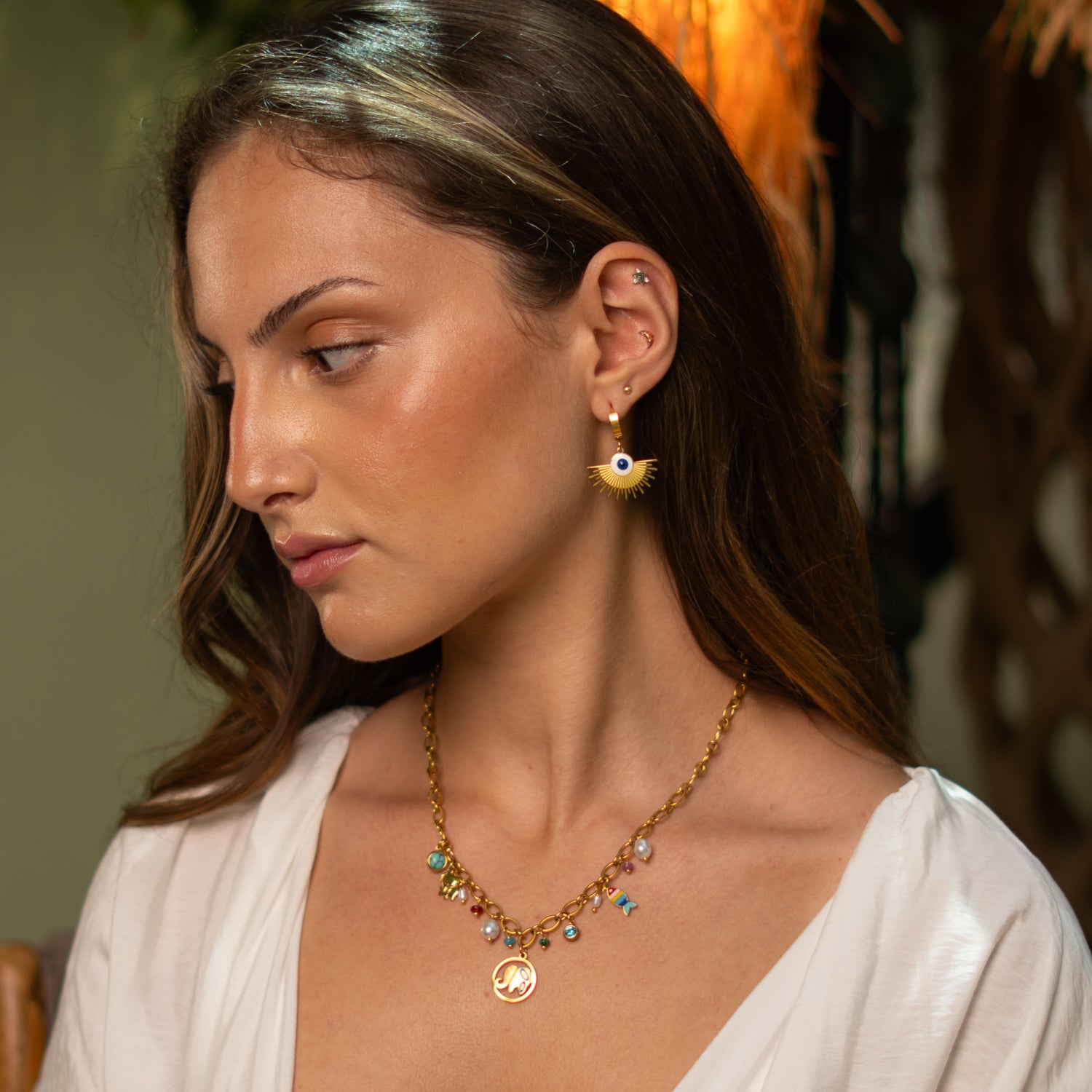 Adjustable gold charm necklace for women with elephant and fish motifs, designed to bring luck and vibrant energy