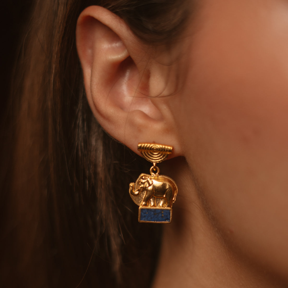 Detail of the Lucky Elephant Lapis Lazuli Gold Drop Earring worn on the ear, 1 inch long