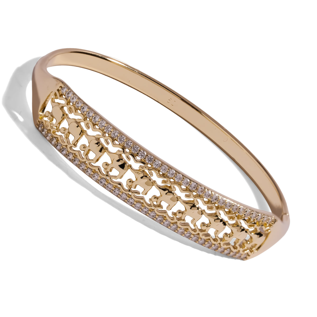 Angled view of the elephant parade gold bangle showing the openwork elephant panel and hinged band