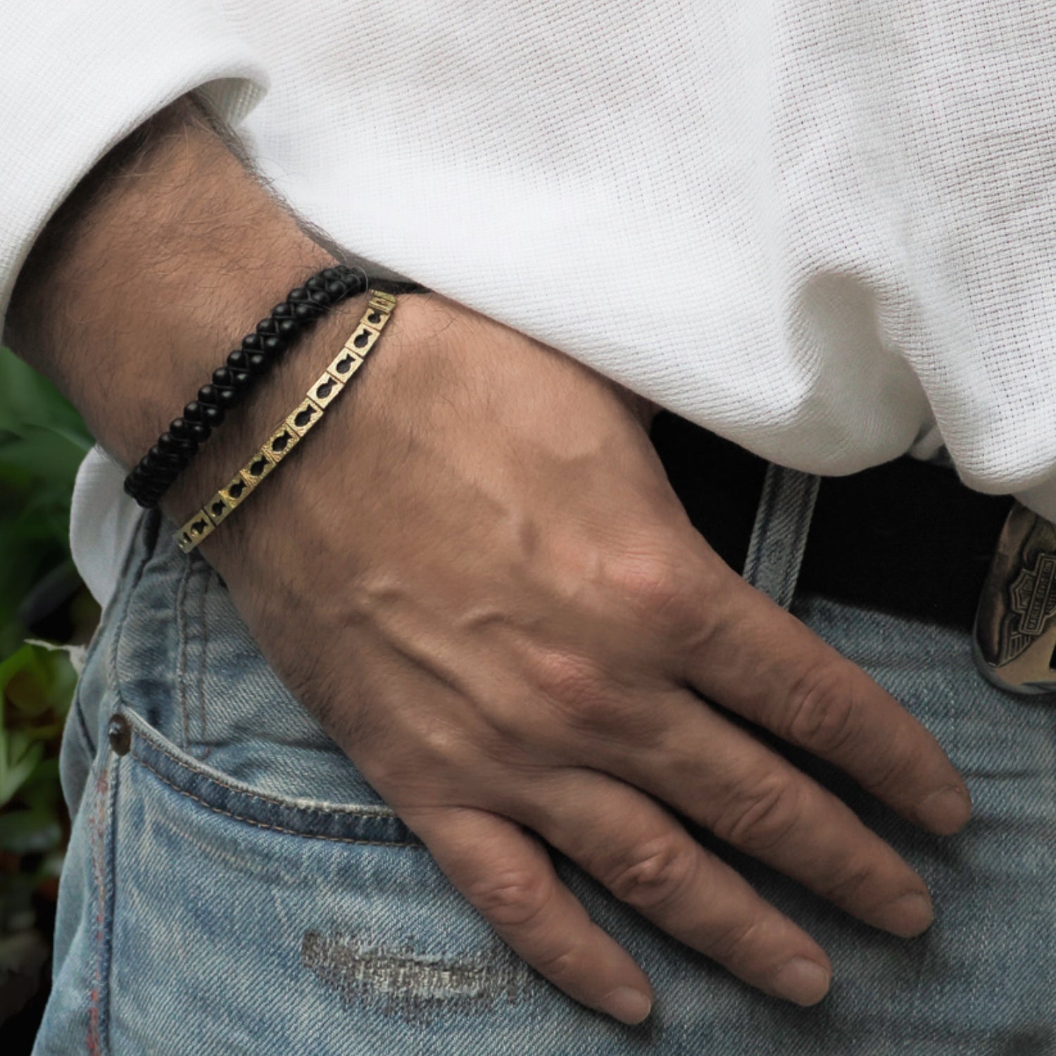 Handcrafted unisex black woven bracelet with gold fish charms symbolizing abundance and prosperity.
