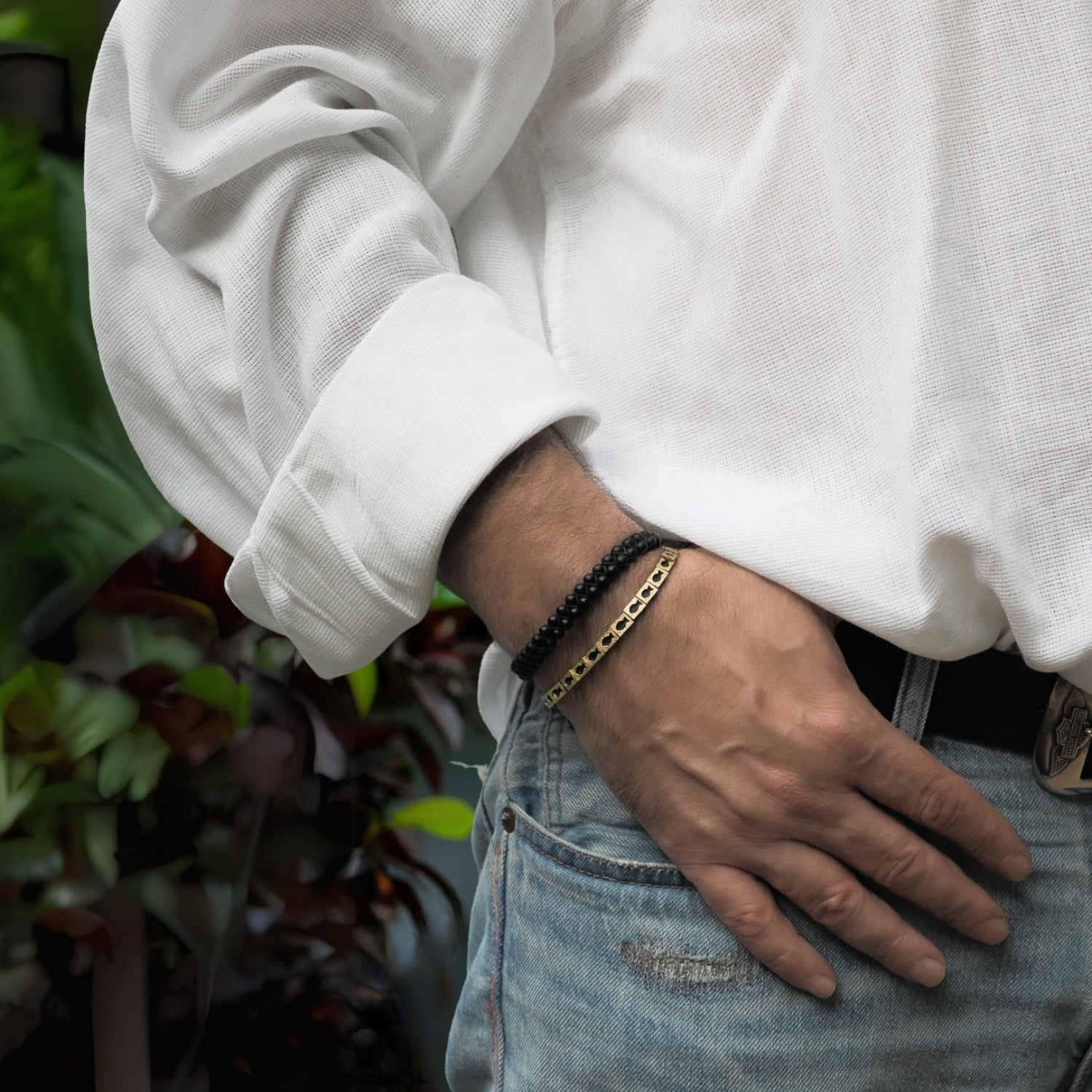 Unisex adjustable Lucky Fish Bracelet featuring a sleek black rope and 18K gold-plated fish charms.
