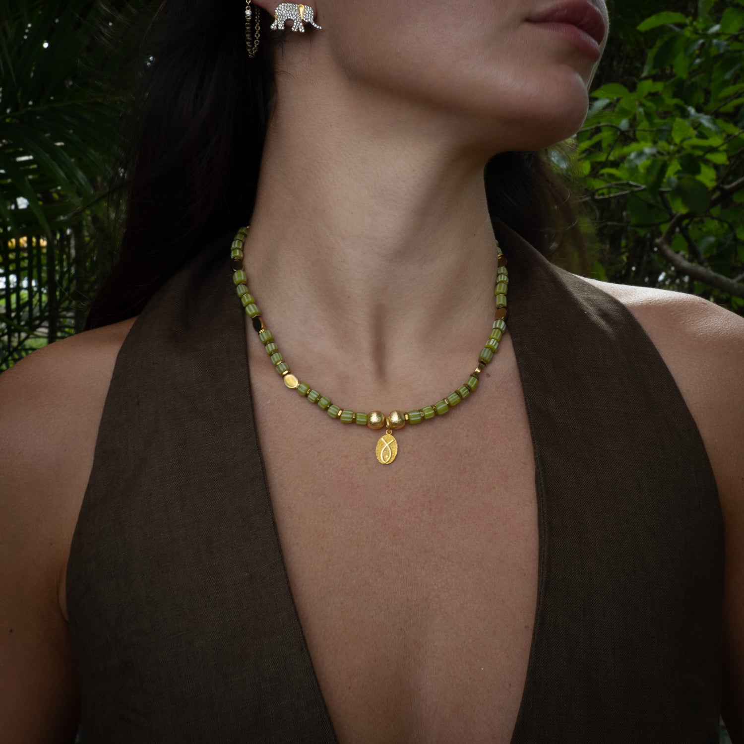 Model wearing Lucky Fish olive beaded choker with sterling silver fish pendant