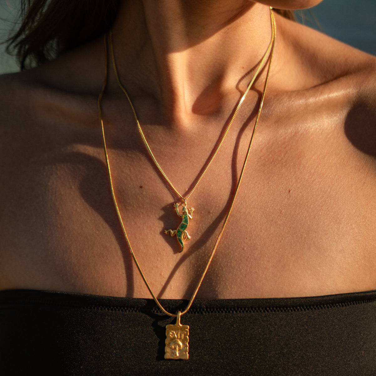 Lucky Gecko malachite pendant layered above the Find Your Way Exit Engraved Gold Pendant Necklace