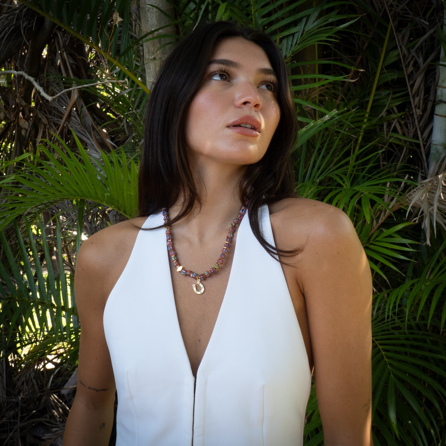 Woman wearing lucky horseshoe African bead bohemian choker with white halter top